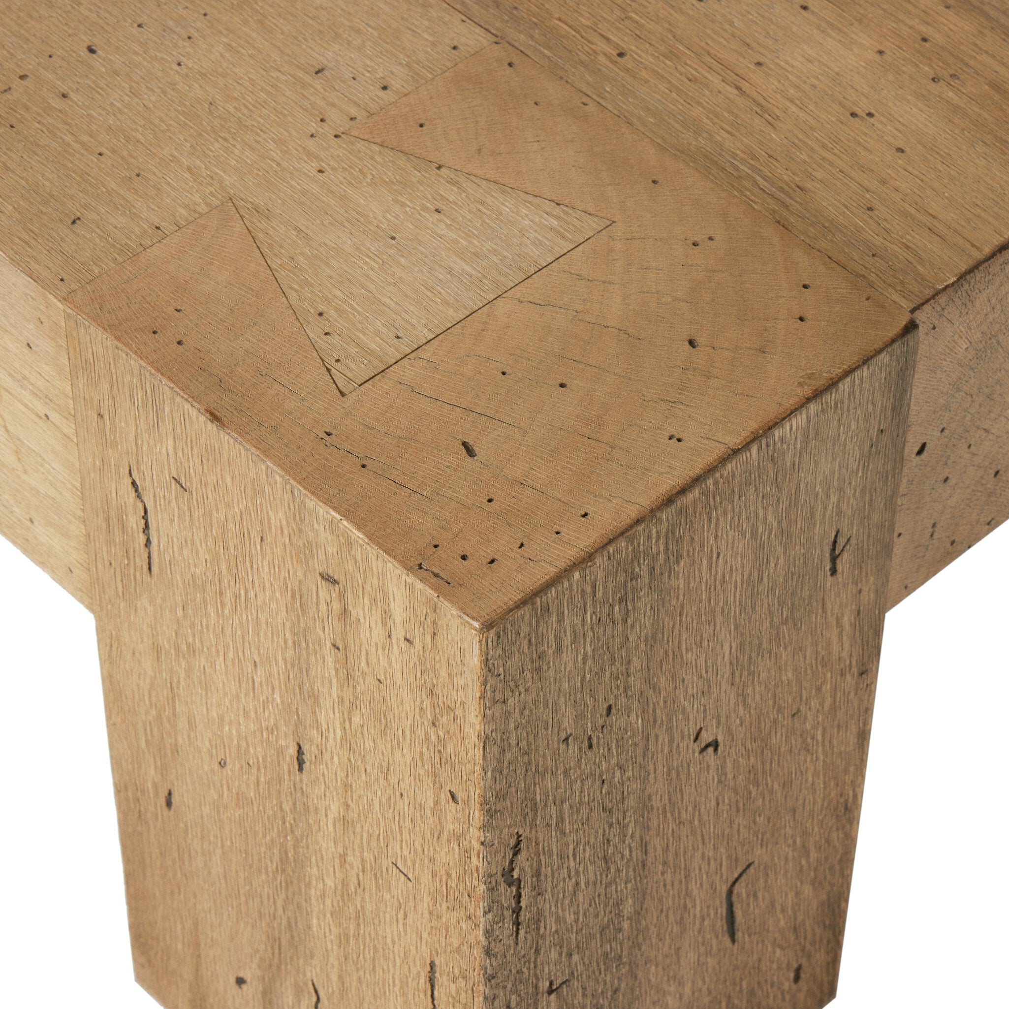 Close up of a thick cut oak veneer coffee table on a white background.