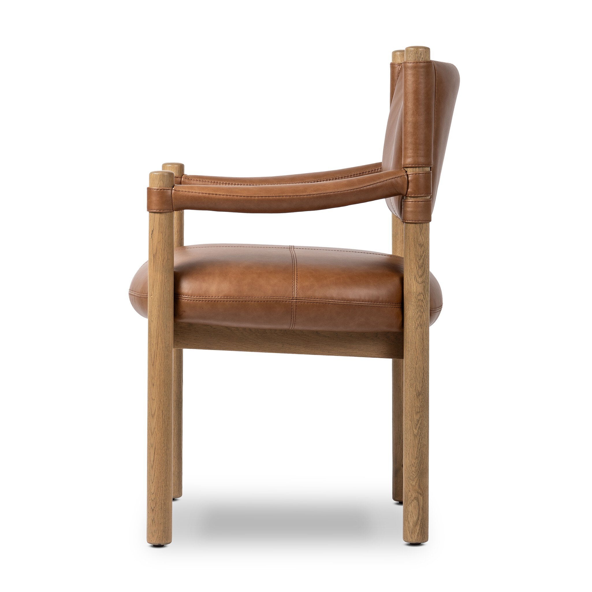 Side profile of a brown leather dining armchair with wooden frame on a white background.