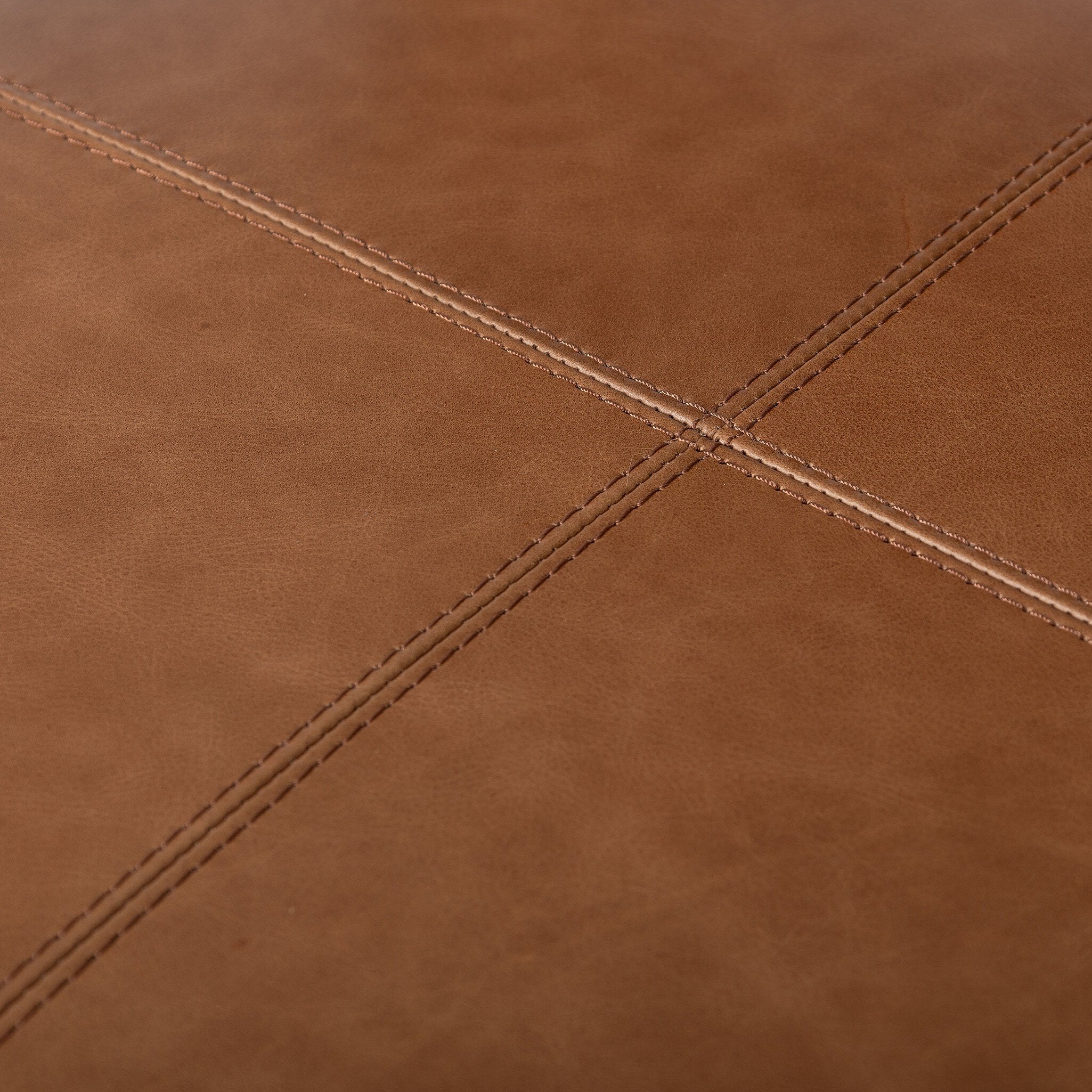 Close-up of brown leather with visible stitching