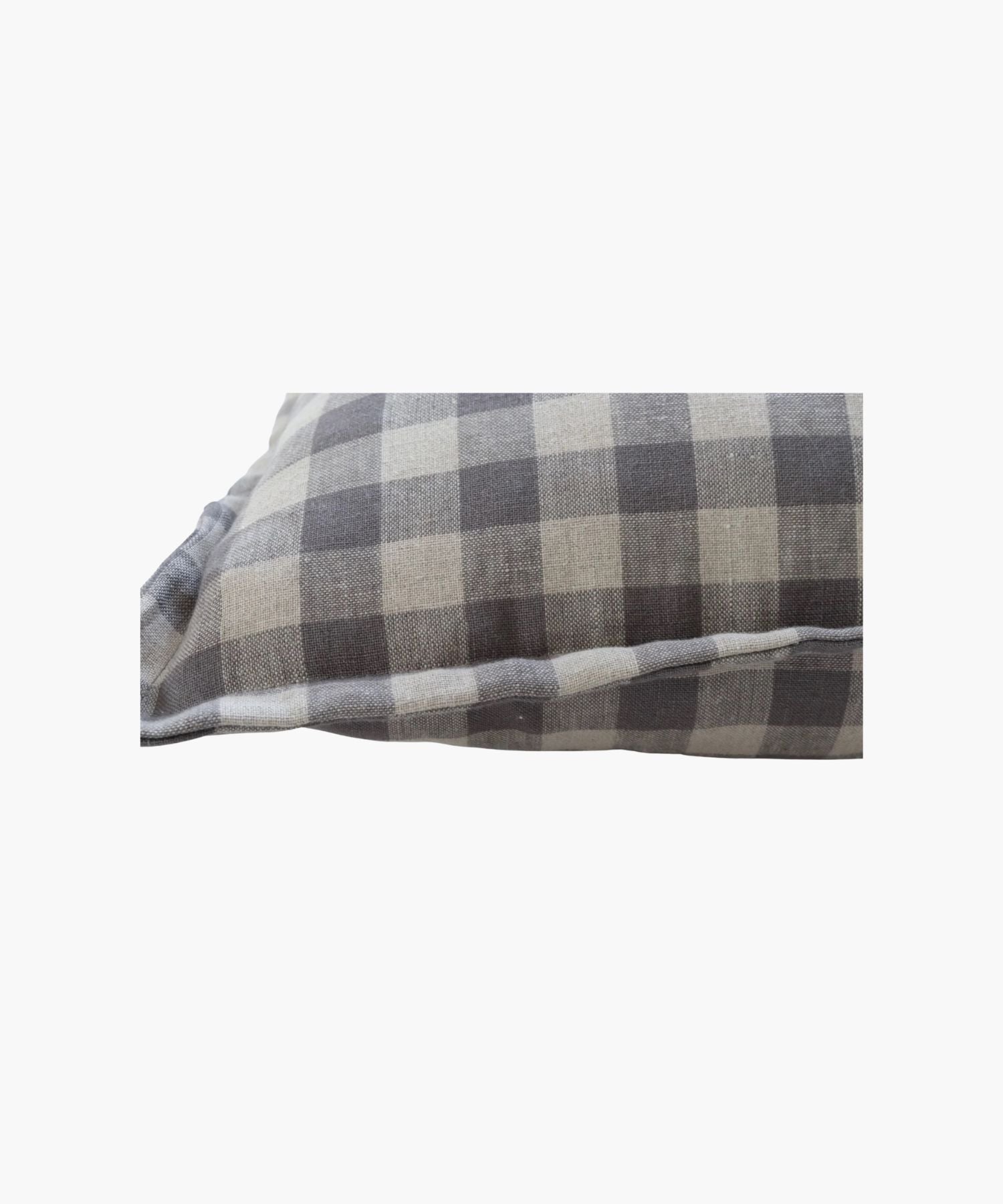 Close up of a pillow cover featuring a blue gray gingham pattern on a natural fabric printed on both sides conveying a cozy and rustic feel.