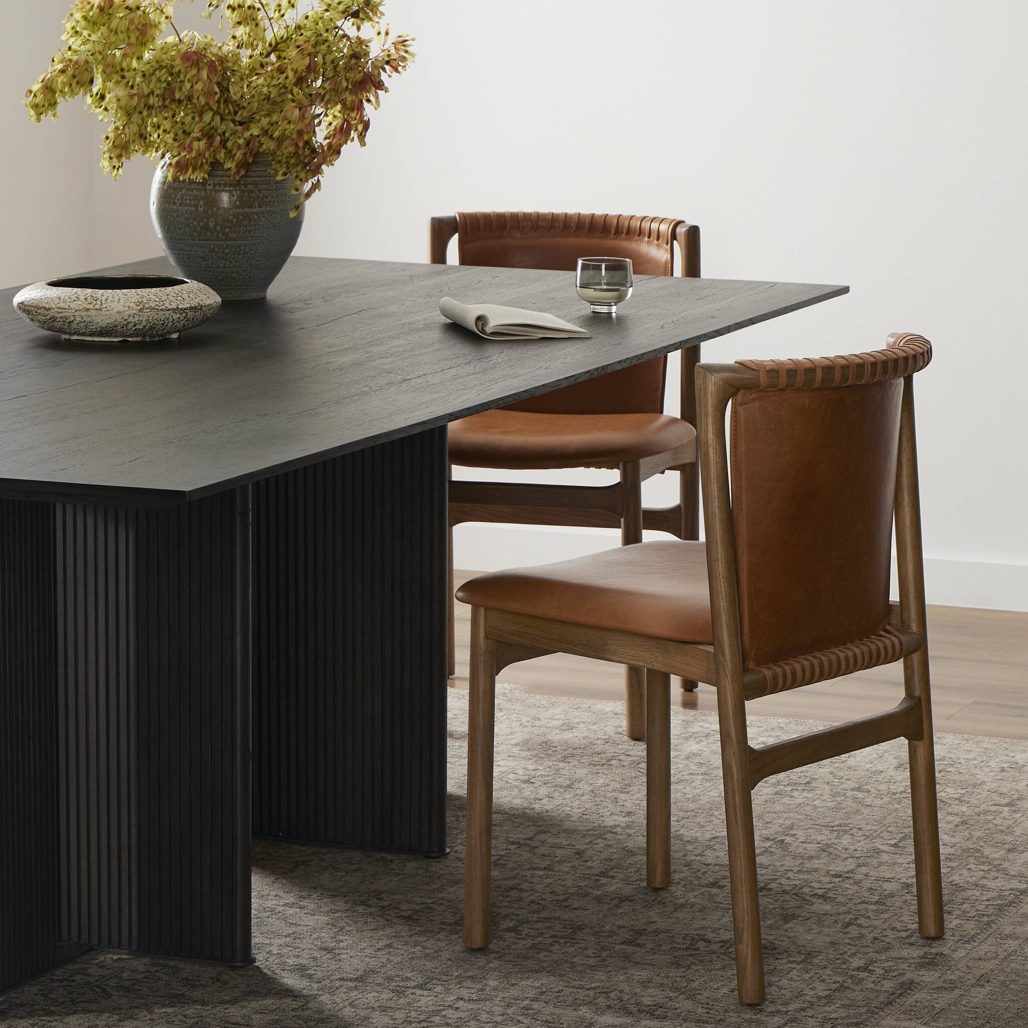 Dining table with brown chairs in a room setting. | Wildwood Home Co.