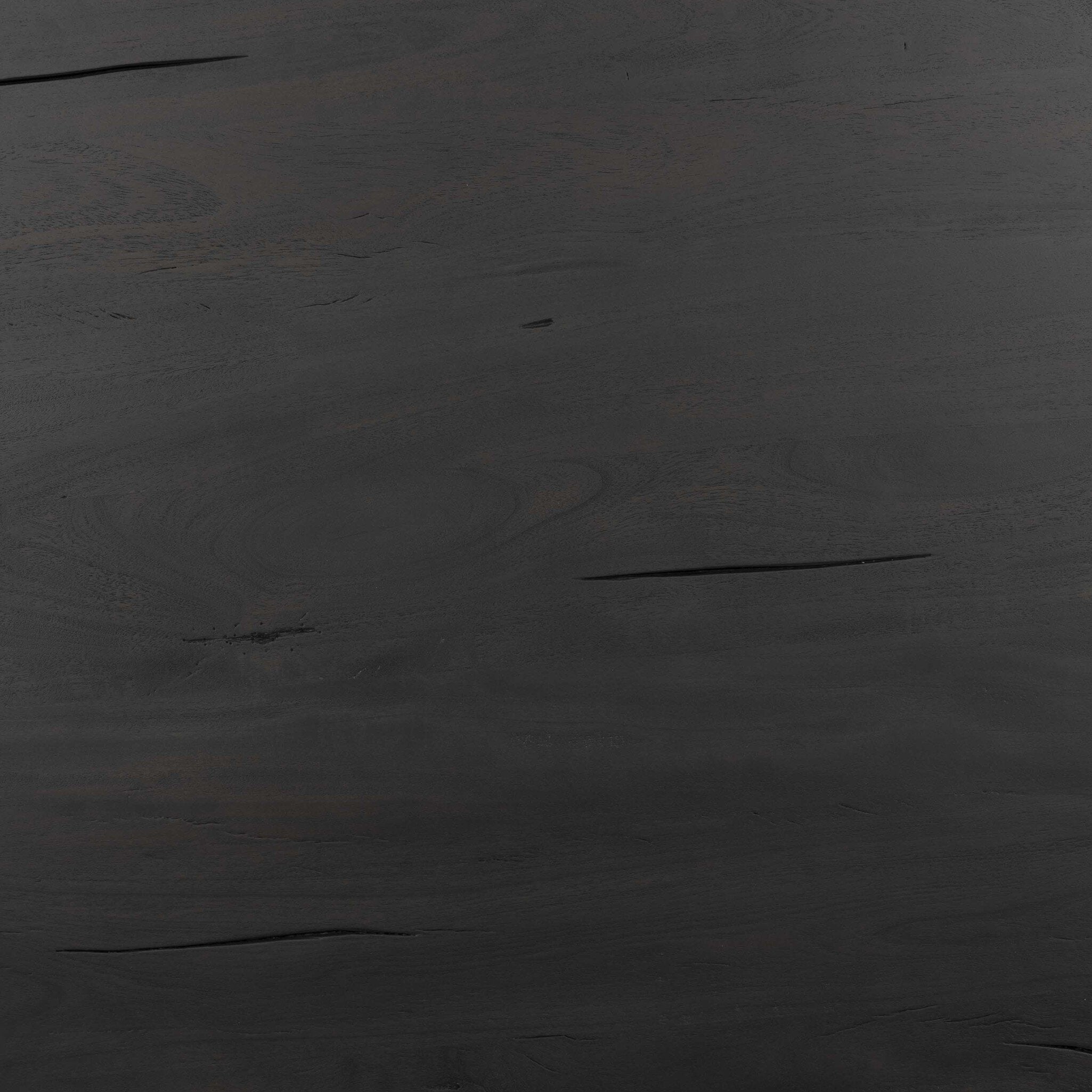 Close up picture of the table top showing its dark finish and reclaimed wood texture.