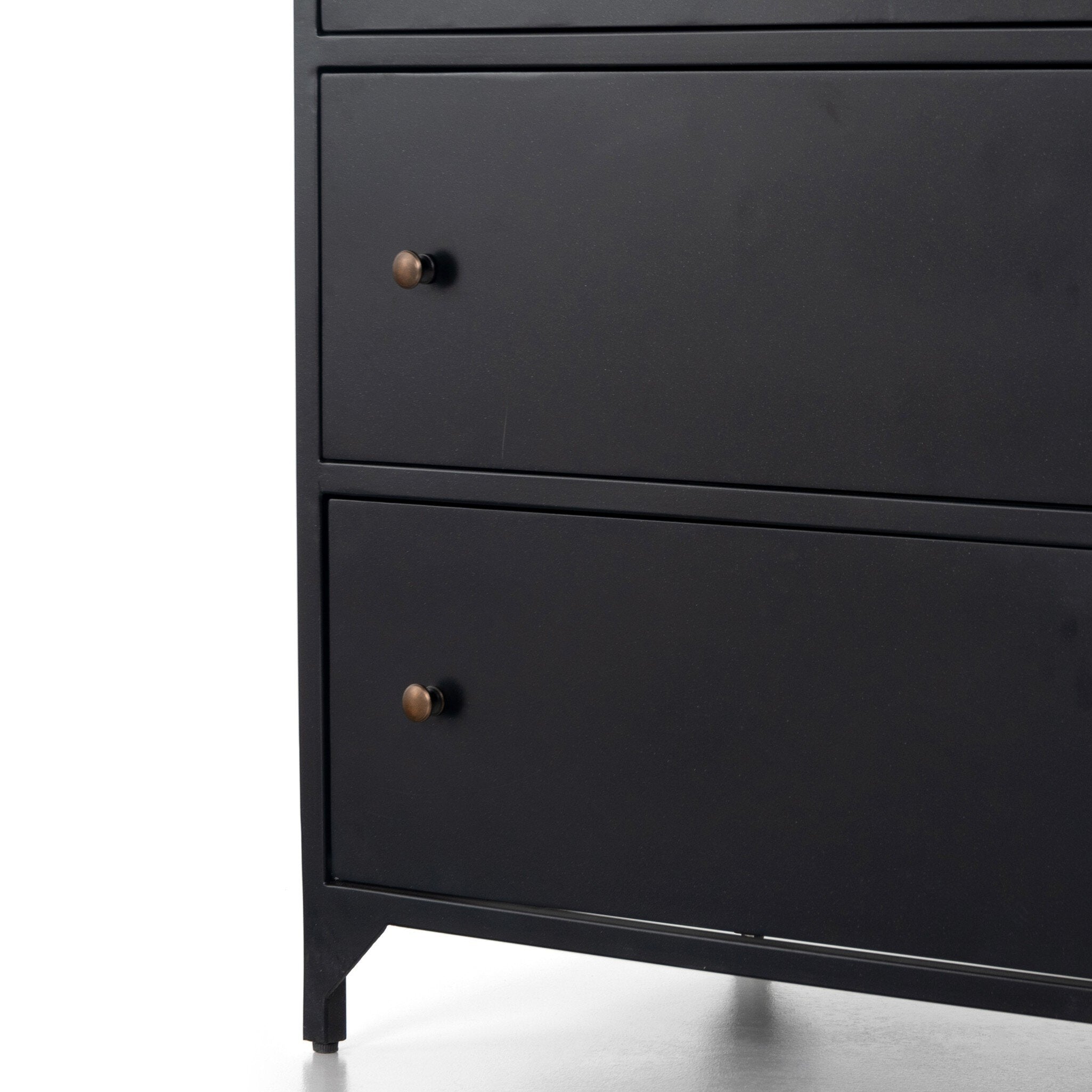 A close up of a black Nightstand with three drawers and metallic knobs on a white background.