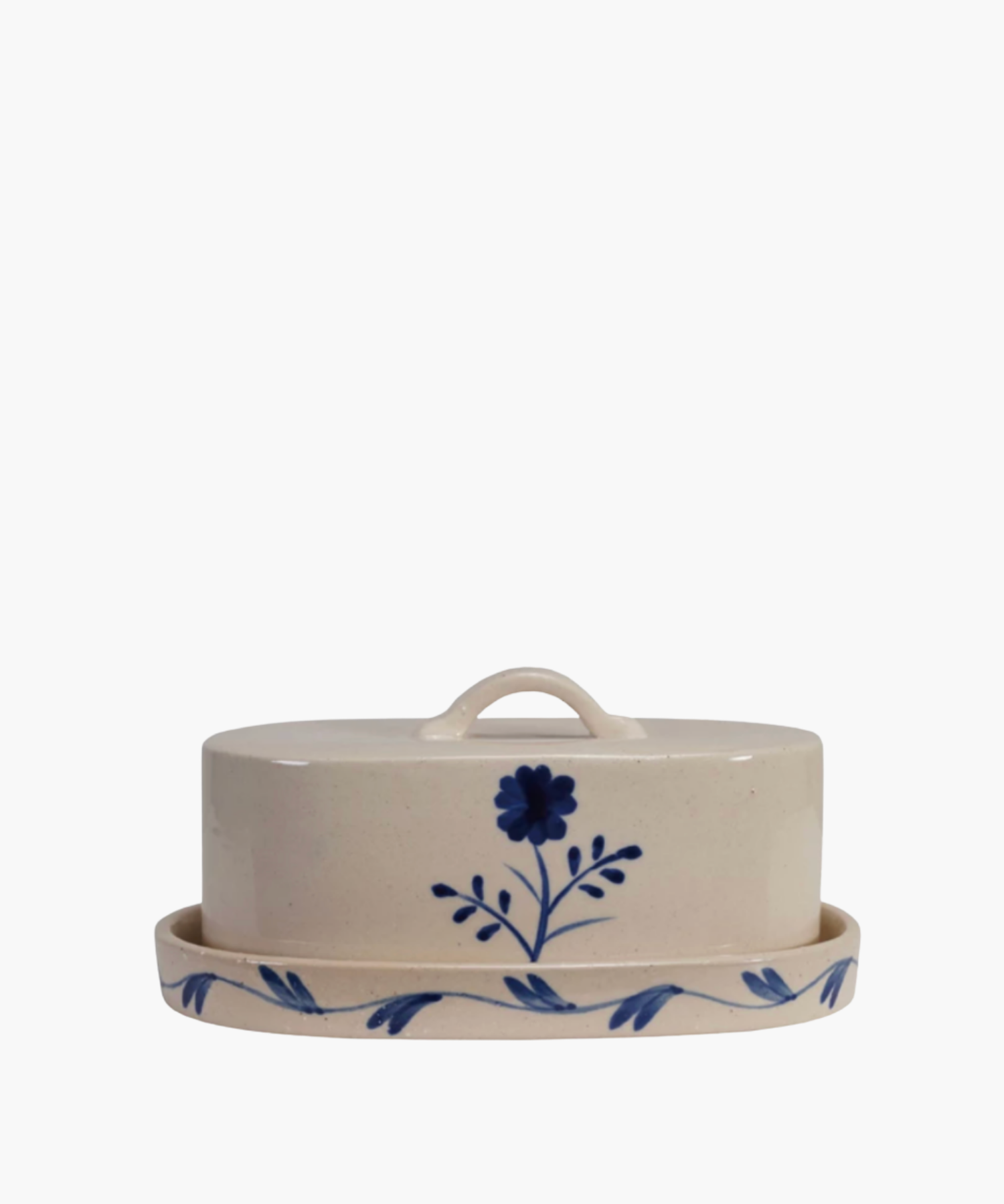 A white ceramic butter dish with a lid, decorated with a hand-painted blue flower and leafy vine pattern, conveying a classic, rustic design. | Wildwood Home Co.