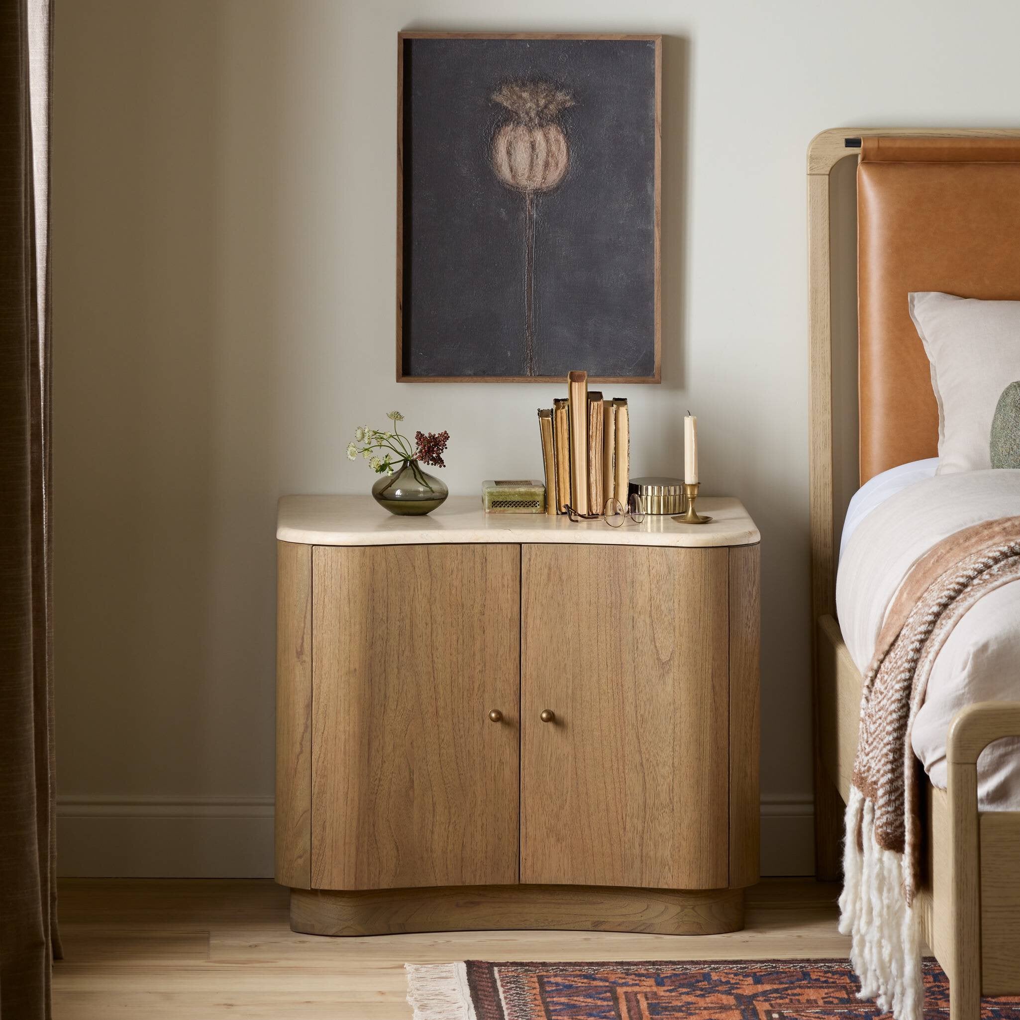 Wooden nightstand with decorative items in a bedroom setting. | Wildwood Home Co.