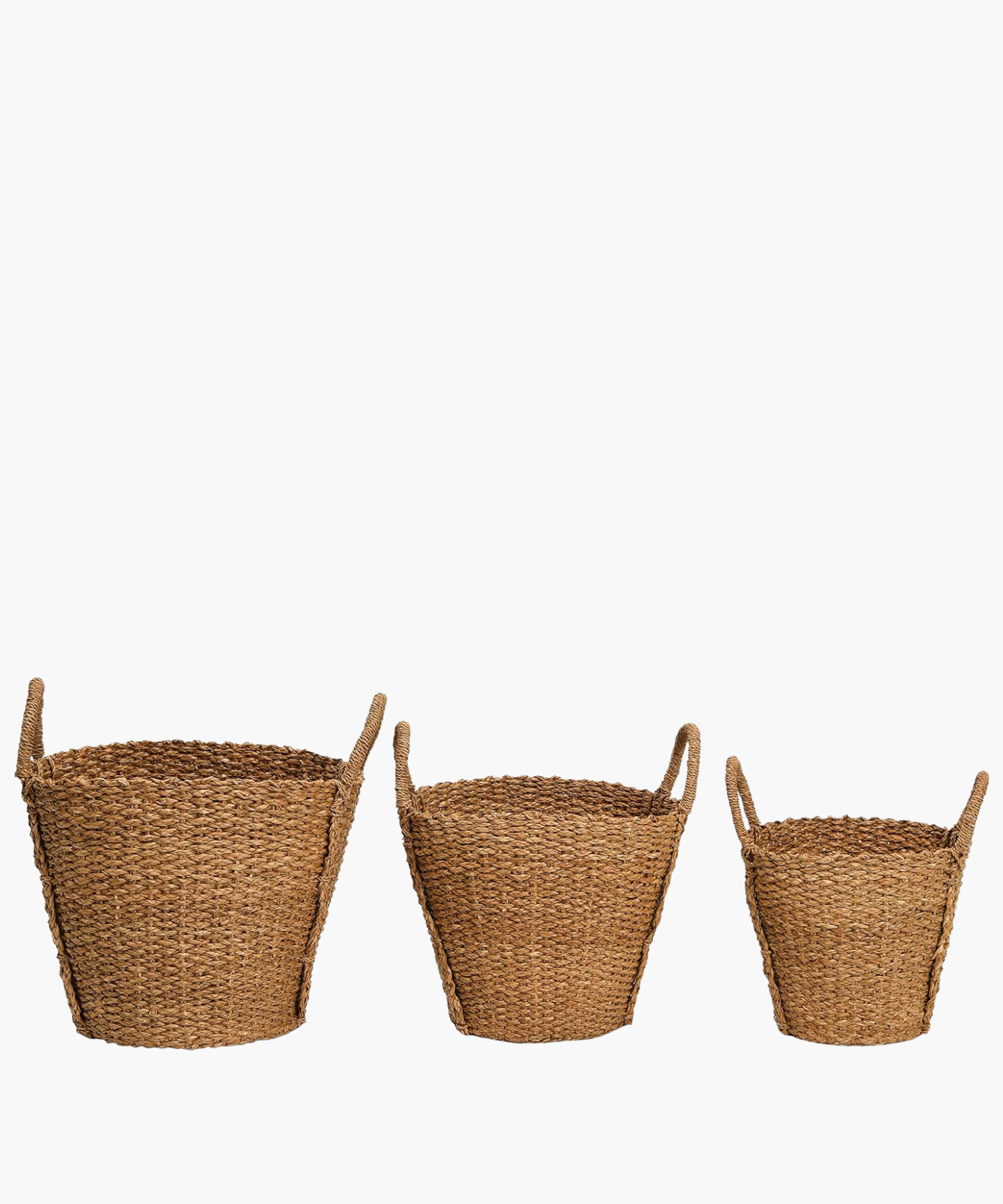 Three hand-woven baskets in various sizes each with two sturdy looped handles. The basket's braided texture conveys a rustic and natural feel, perfect for storage or decoration. | Wildwood Home Co.