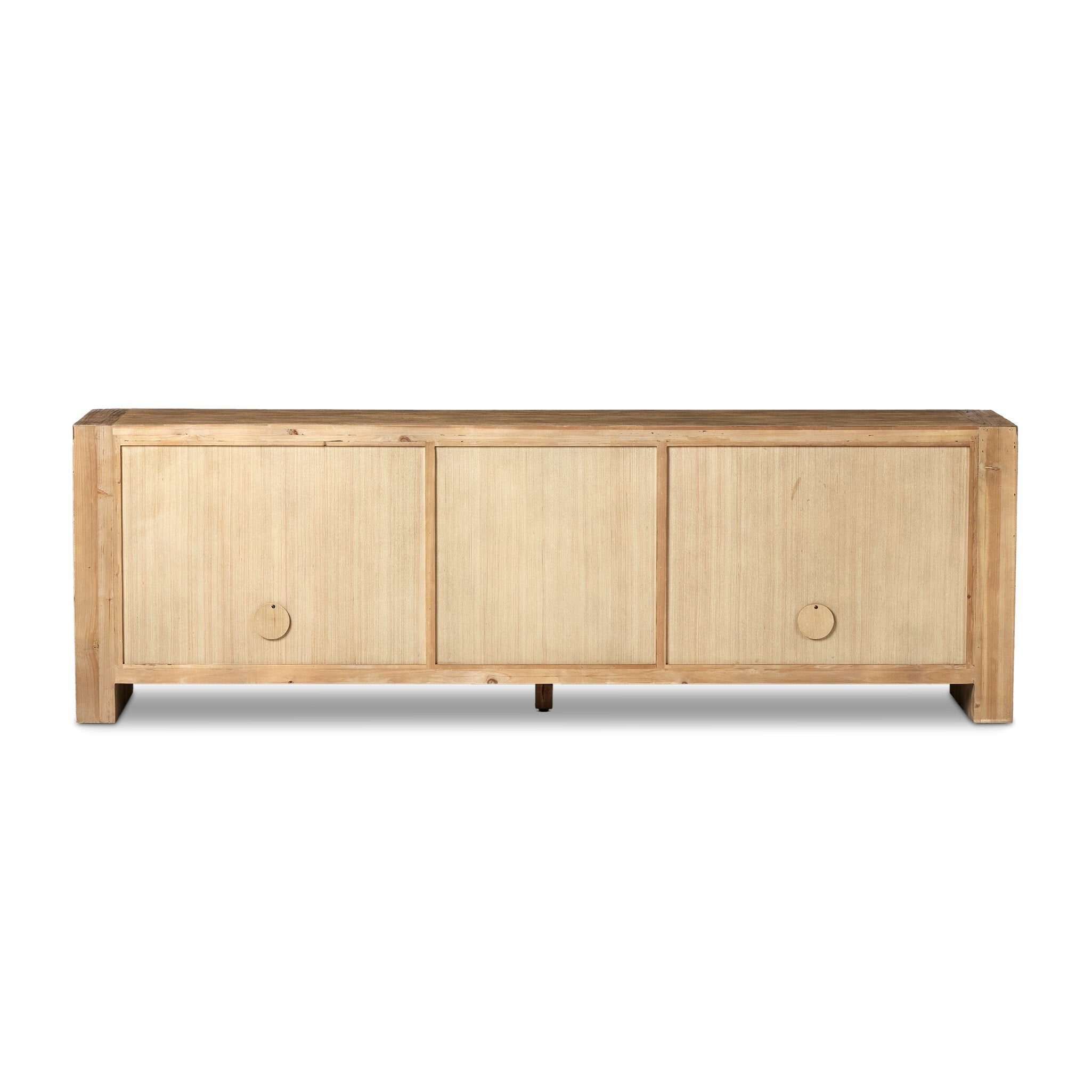 The back of a wooden sideboard with four doors and three drawers in the center on a white background.