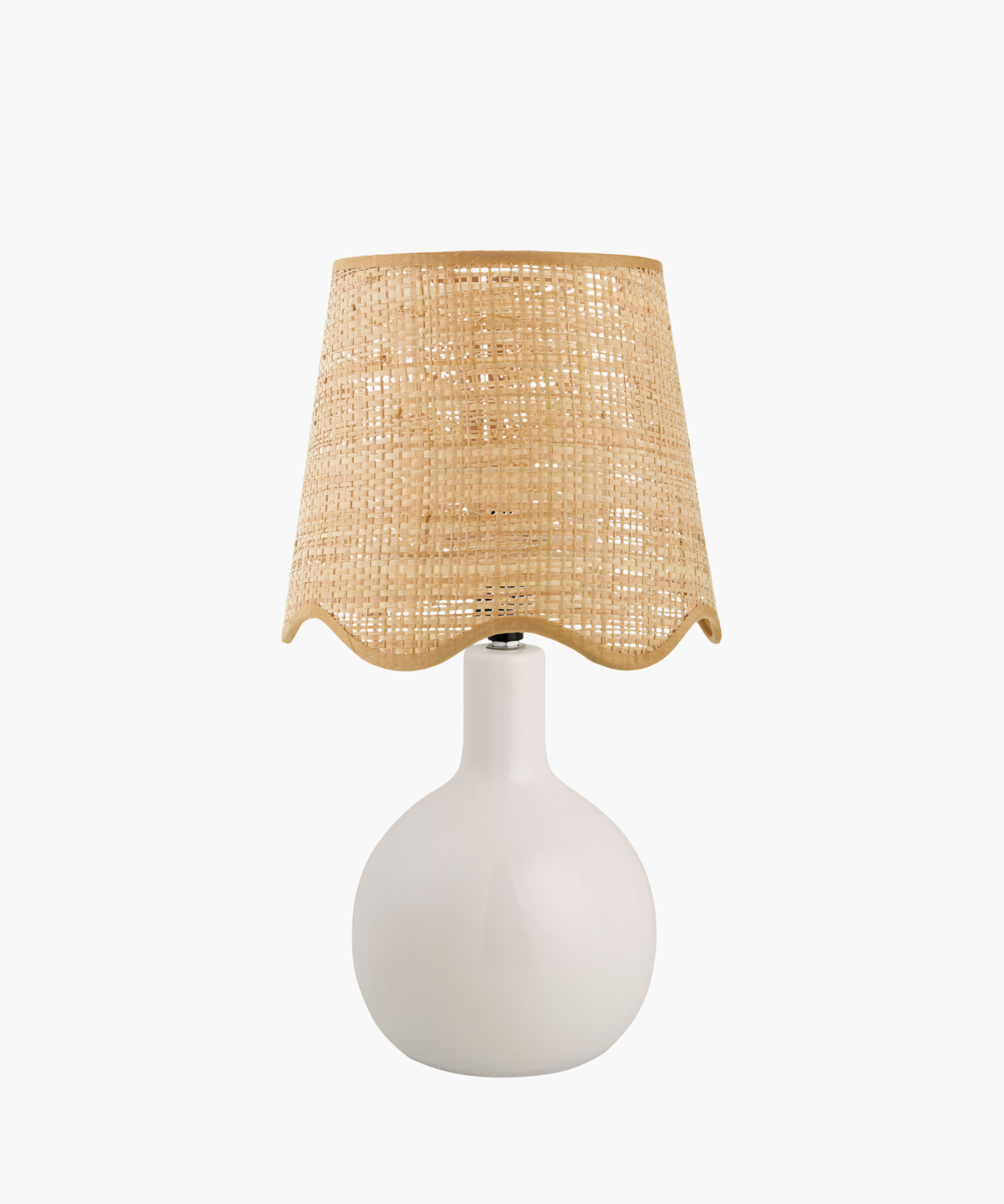 A modern table lamp with a sleek white ceramic base and a woven beige rattan shade. The design is minimalist, giving a cozy, natural feel. | Wildwood Home Co.