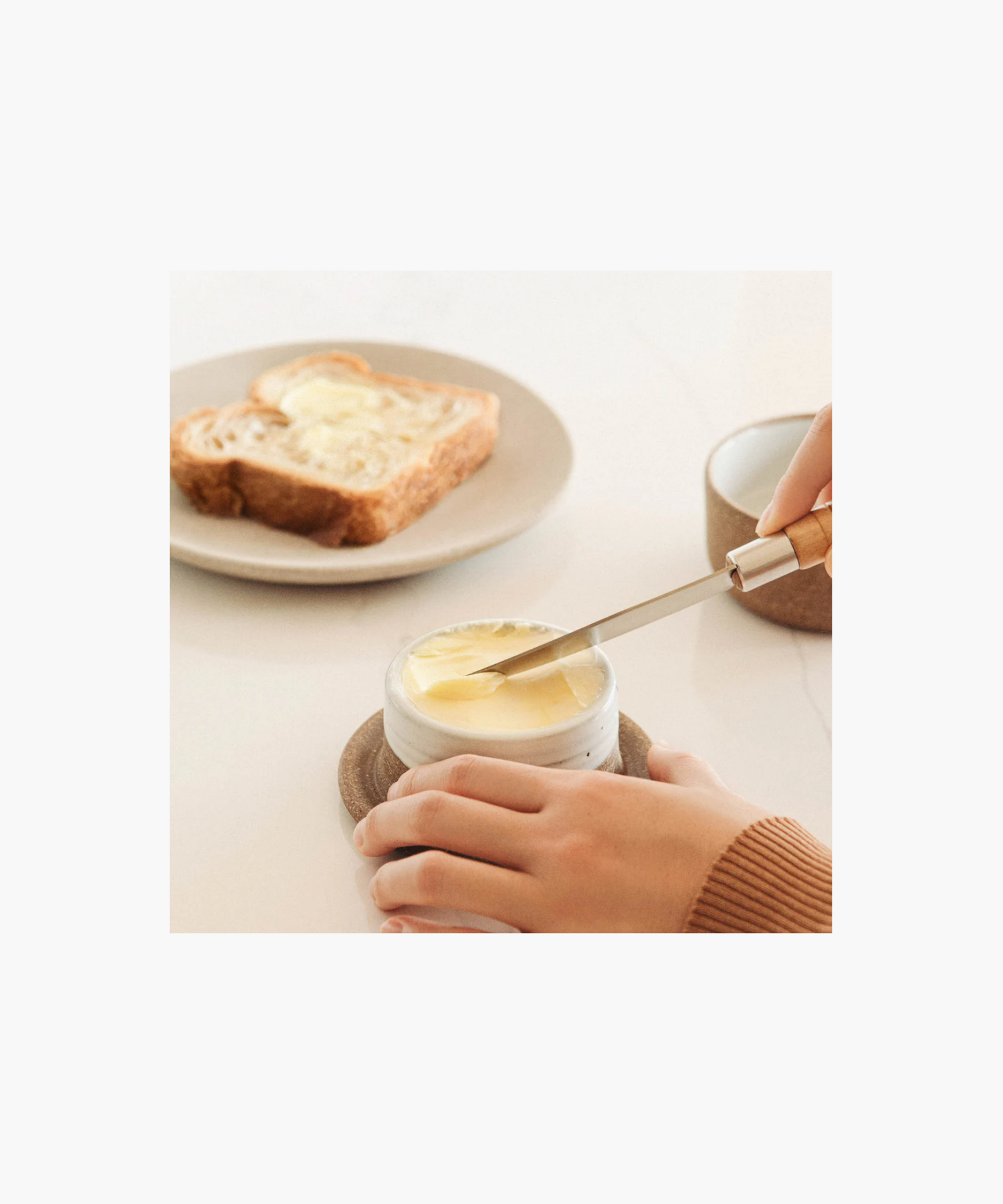 Ceramic butter keeper styled with bread and butter showing a minimalist design. | Wildwood Home Co.