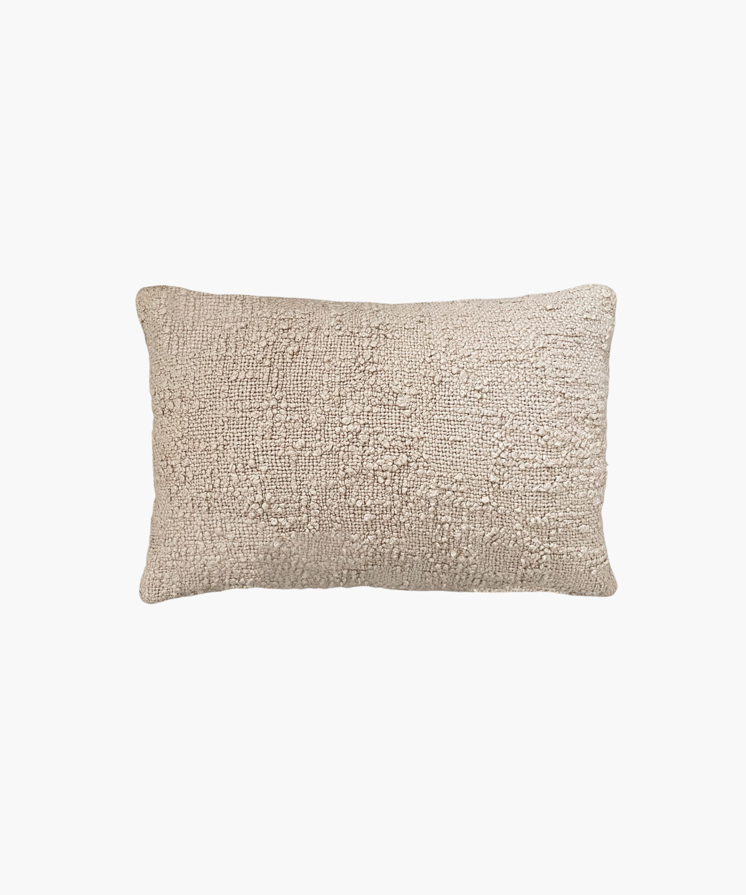 A rectangular lumbar beige pillow with a textured, woven surface. The pillow appears soft and cozy, evoking a sense of warmth and comfort. | Wildwood Home Co.