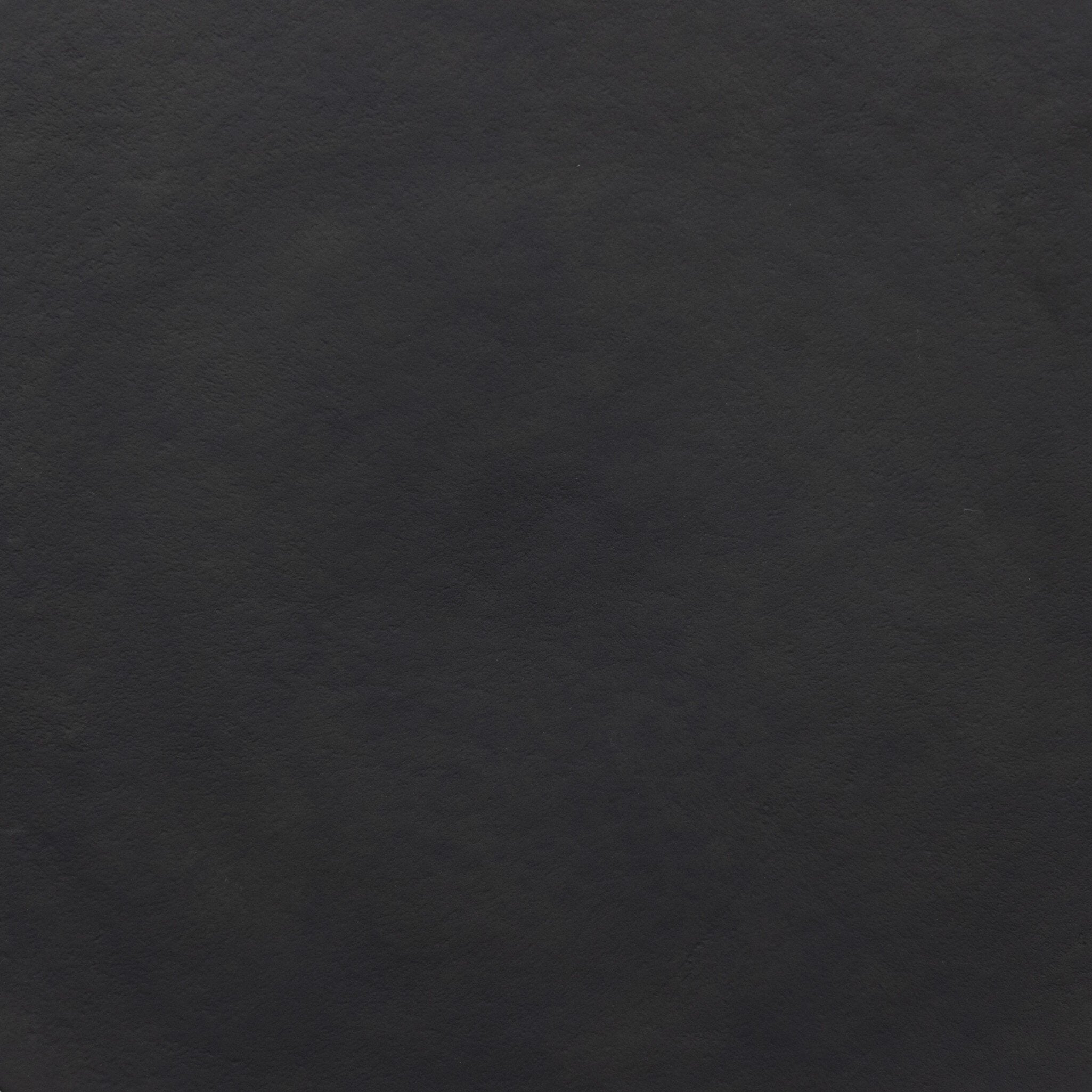 Close up picture of the table top showing it's antique black finish and texture.