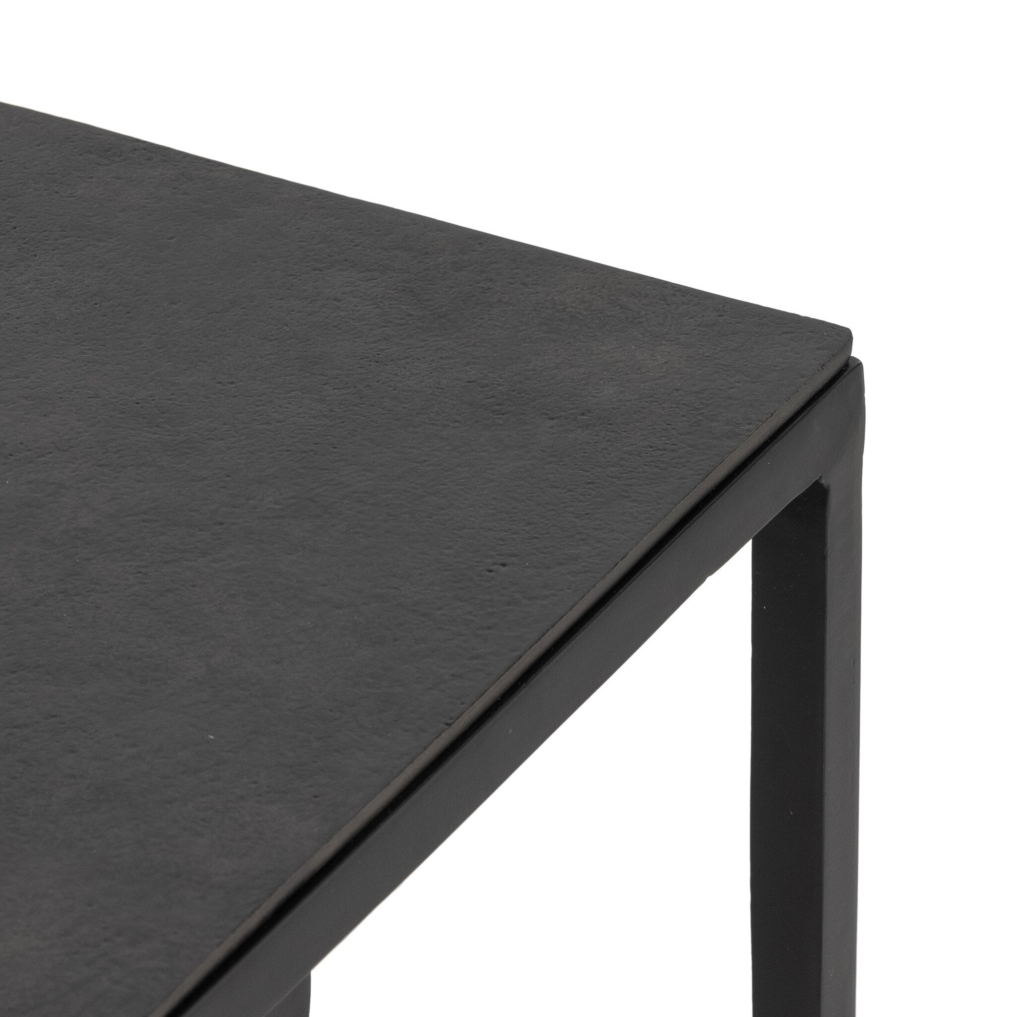 Two black nesting tables with tapered legs and squared off aluminum tops on a white background.