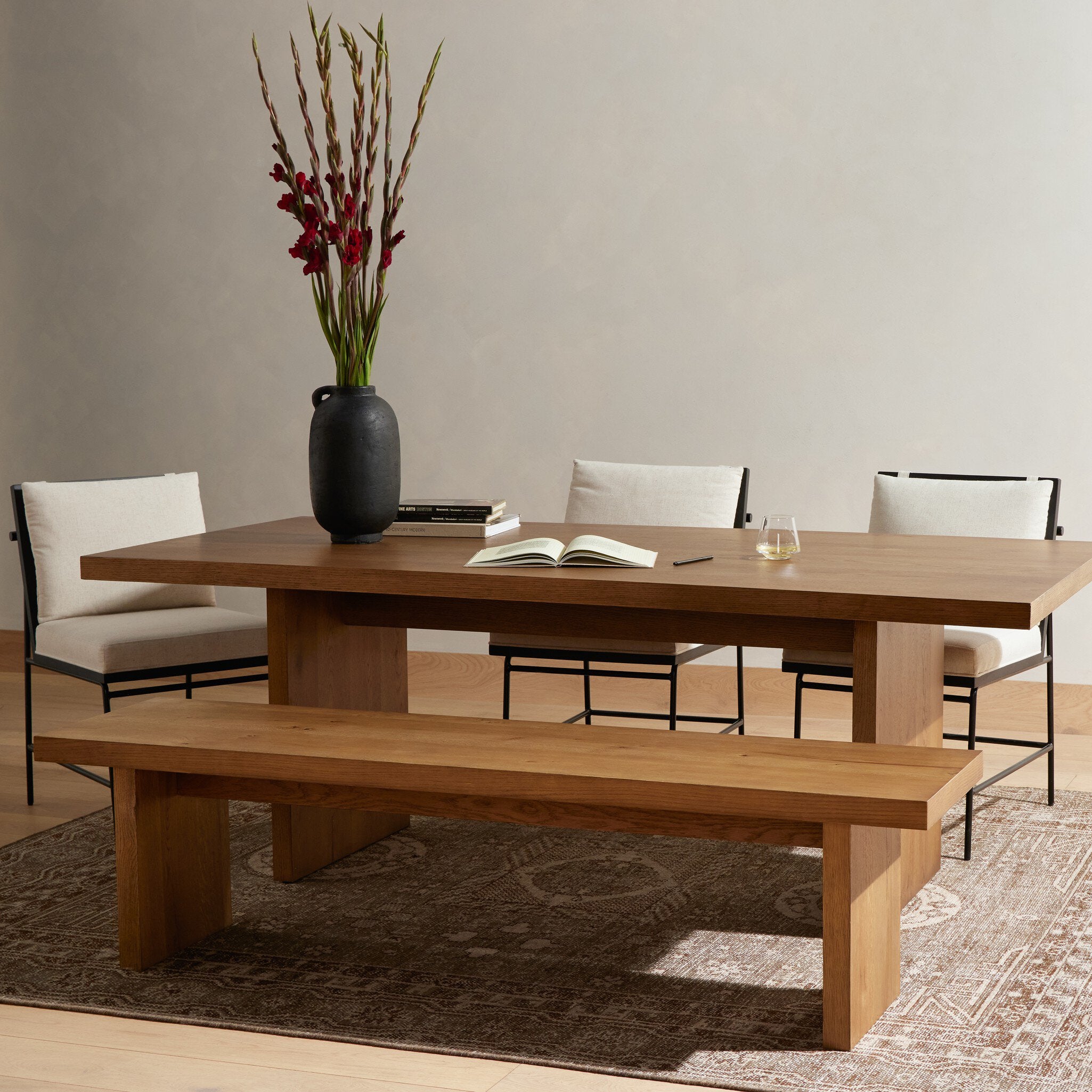 Wooden dining table with bench and chairs in a room setting. | Wildwood Home Co.