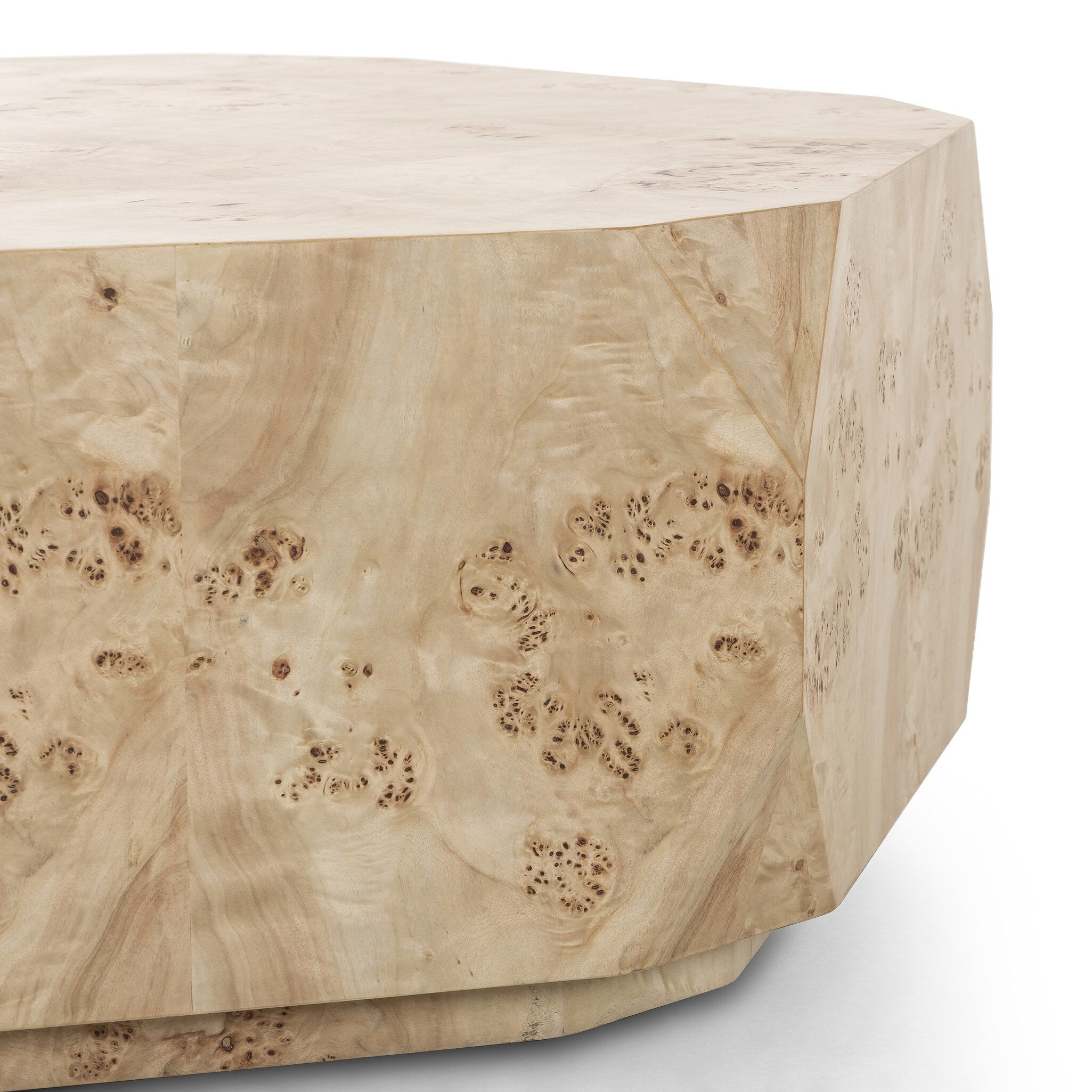 Close up of an organic-looking shaped coffee table with a natural finish on a white background.