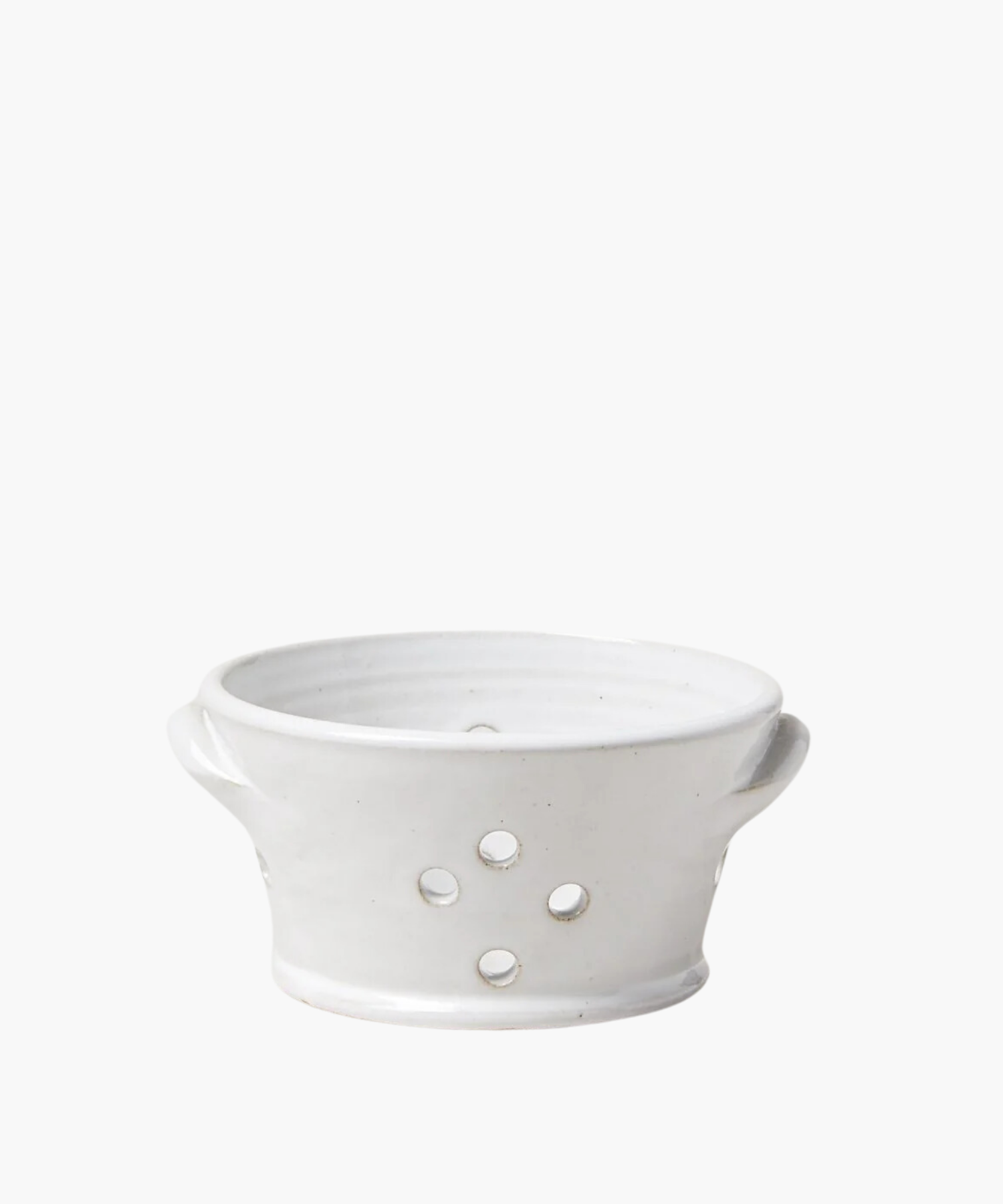 White ceramic colander with two side handles and five round drainage holes. The smooth, minimalist design conveys a clean and simple aesthetic. | Wildwood Home Co.