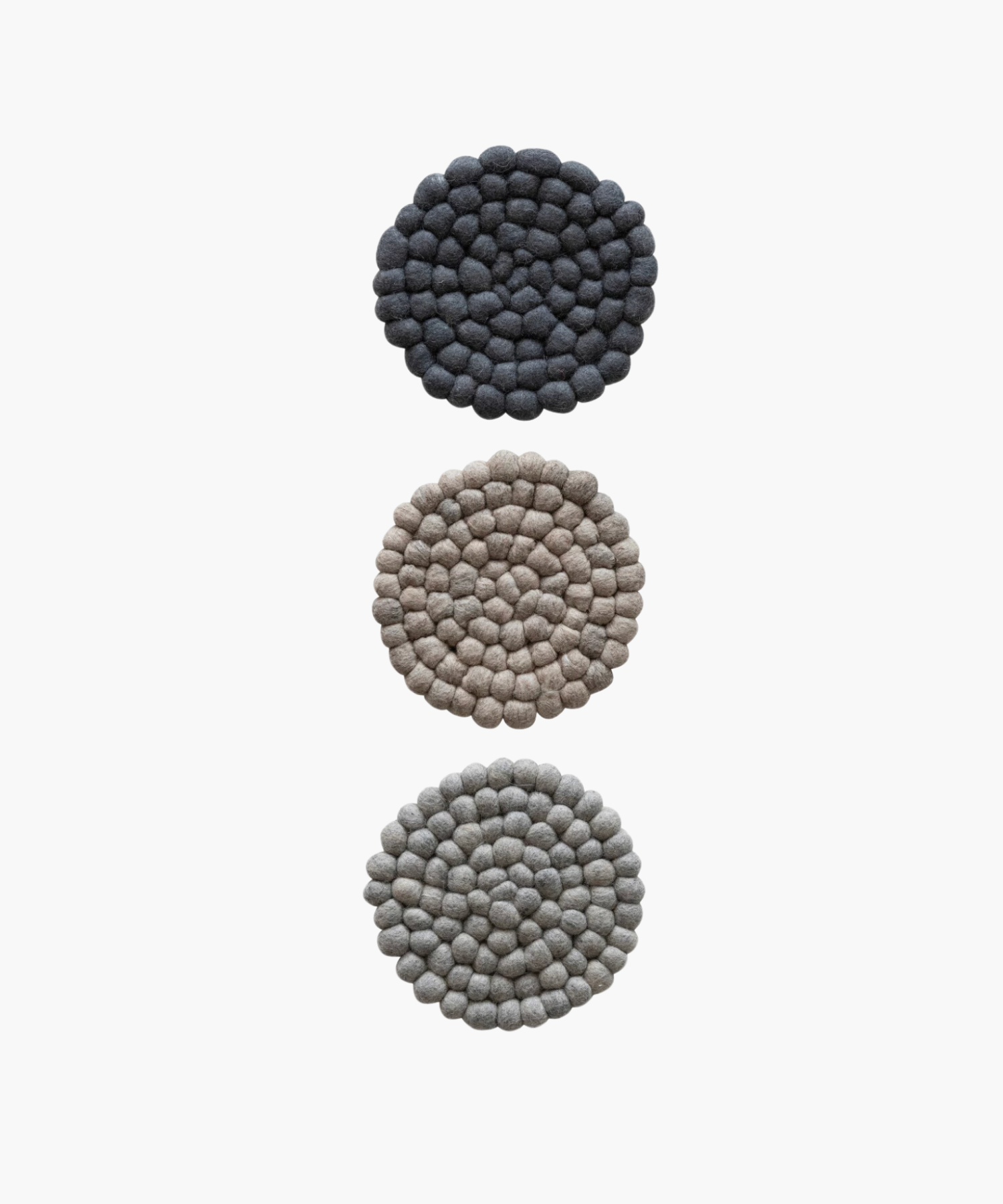 Three Circular felt ball trivet in soft, neutral tones. The textured surface features concentric rings of tightly packed, round felt balls for a cozy, rustic feel. | Wildwood Home Co.