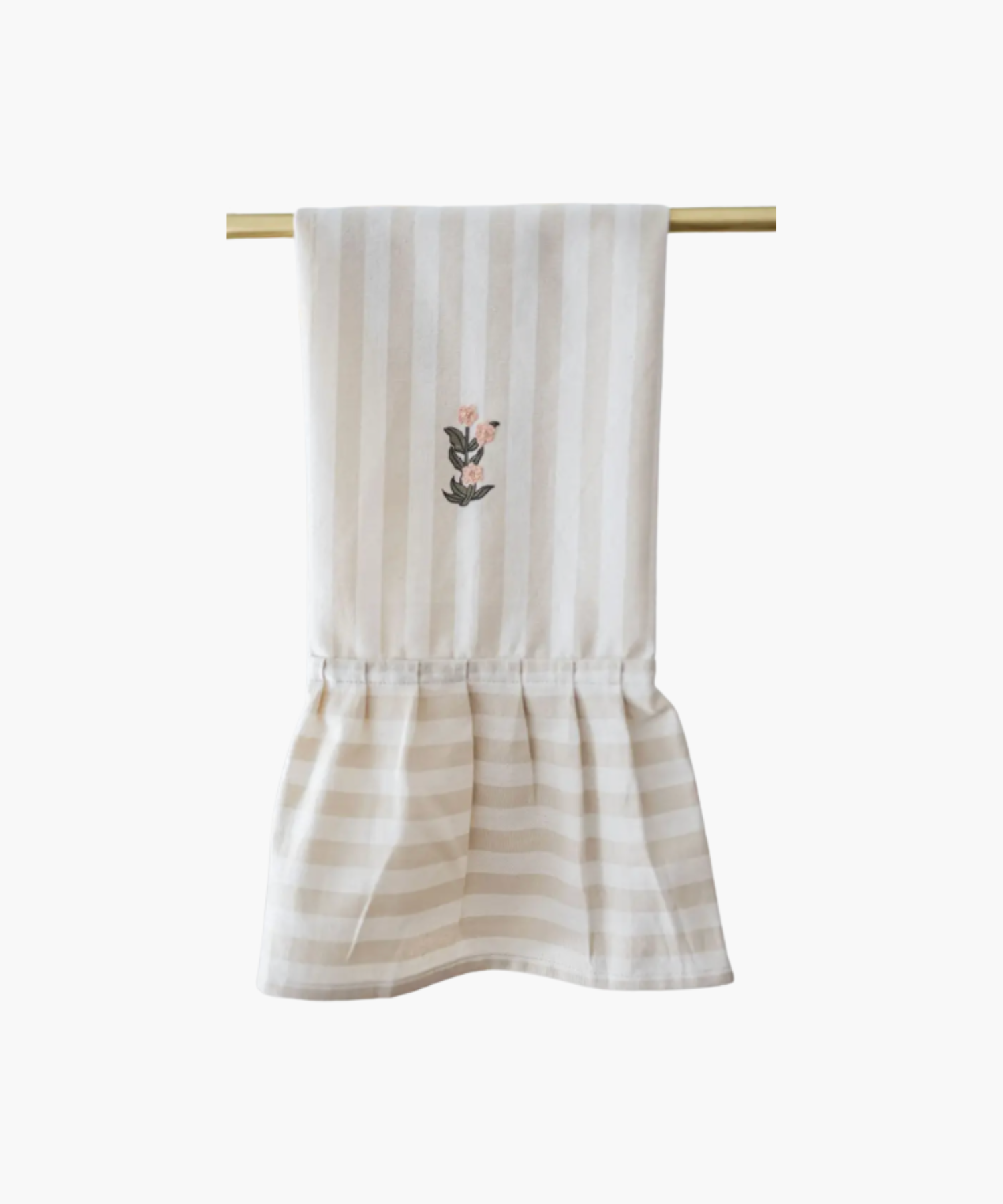 A beige striped kitchen towel is hanging on a gold rod, featuring an embroidered floral motif in the center. The gathered ruffle adds an elegant touch. | Wildwood Home Co.