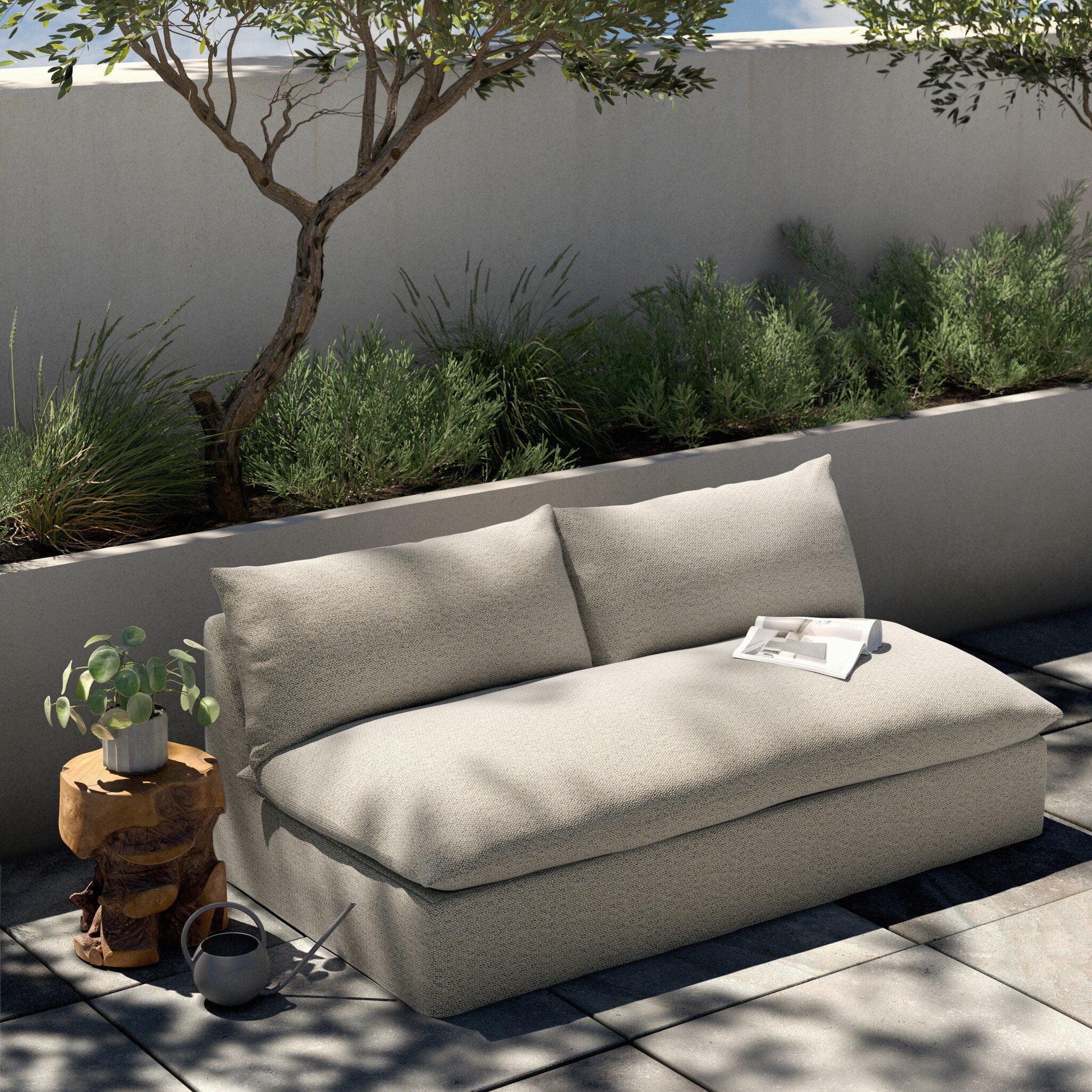 Beige outdoor sofa with a small table and plants in a garden setting. | Wildwood Home Co.