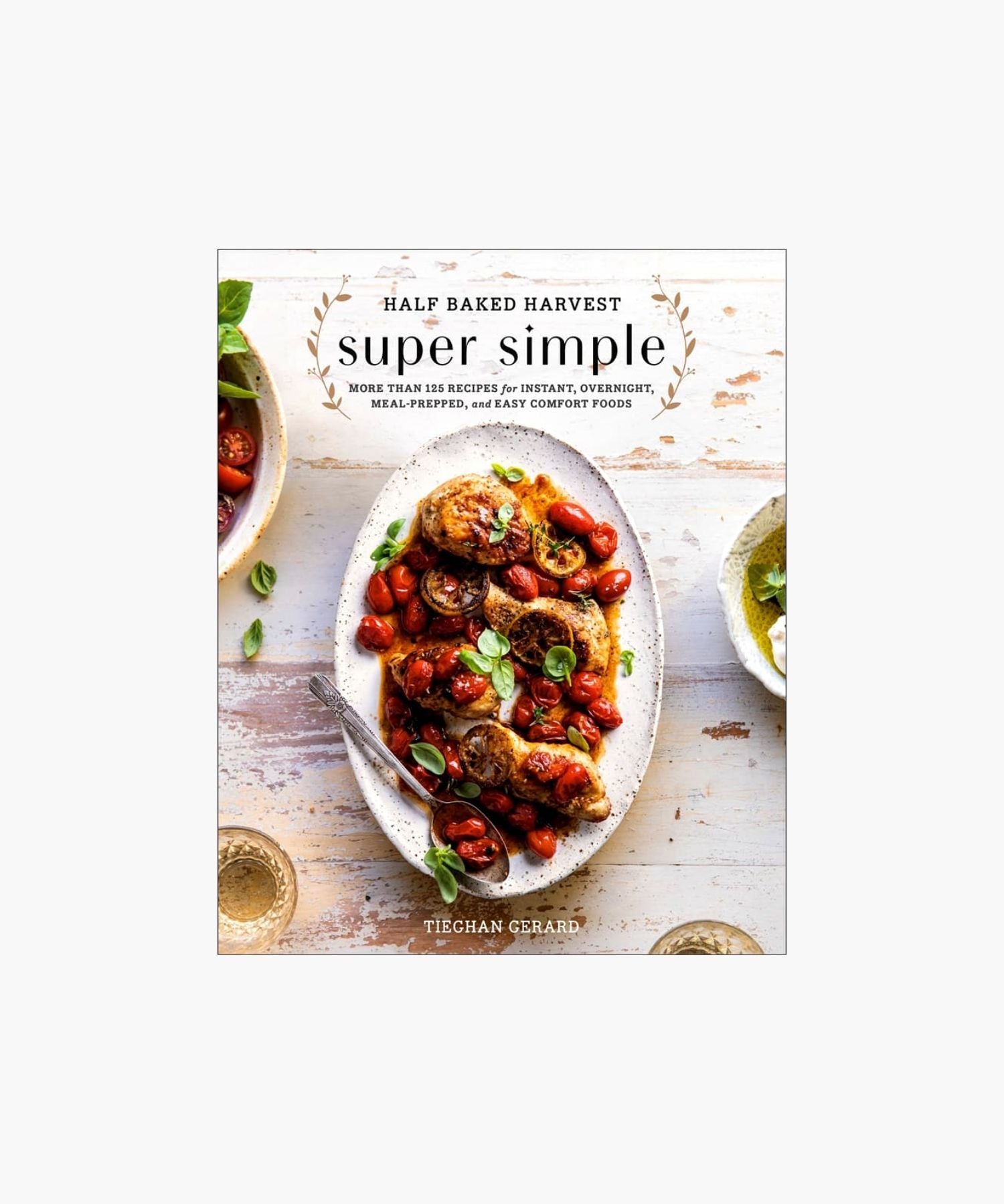 Cookbook cover titled "Half Baked Harvest: Super Simple" by Tieghan Gerard, featuring a plate of roasted chicken with cherry tomatoes and herbs on a rustic table. | Wildwood Home Co.