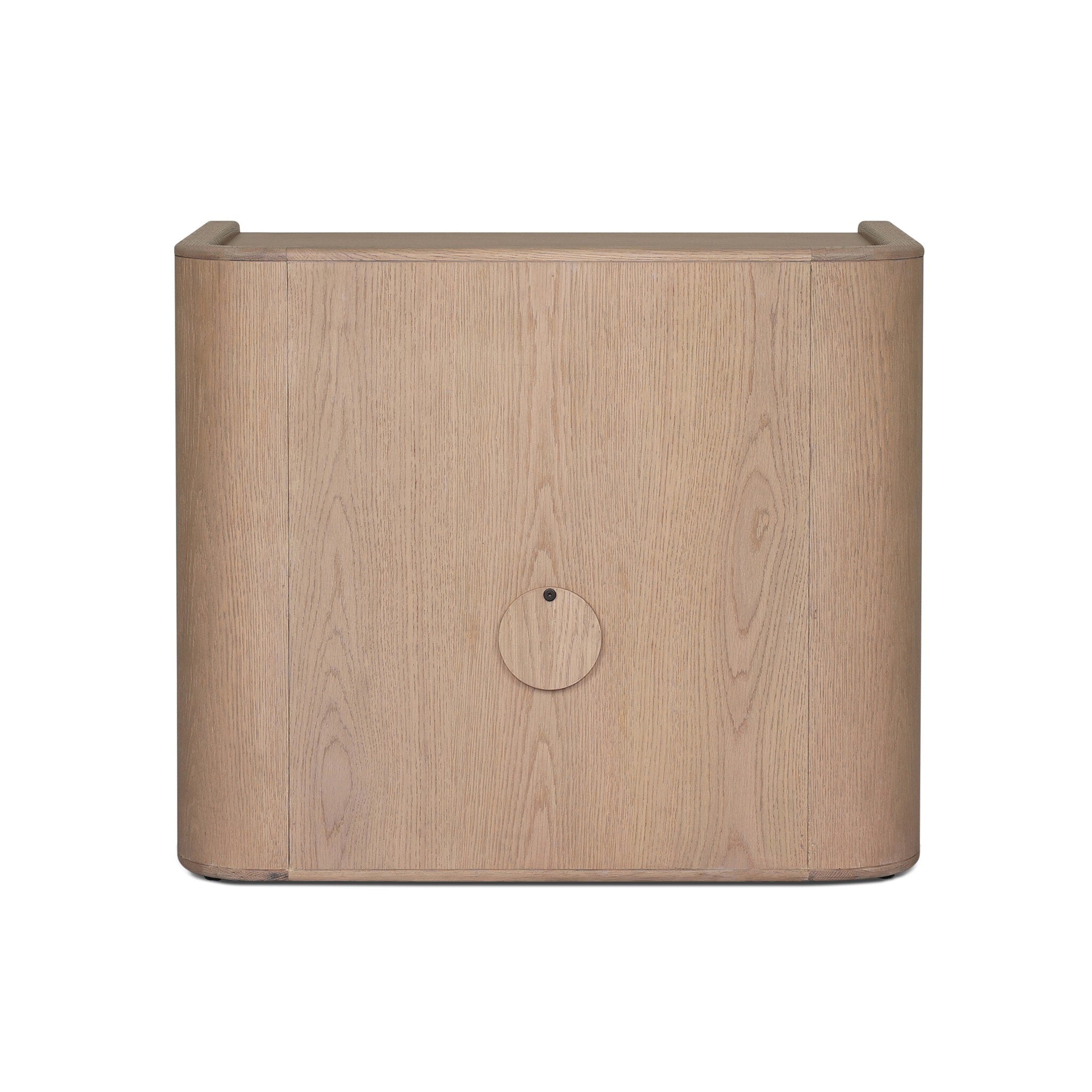 The back of a small cabinet style nightstand with two doors and split circle hardware on a white background.