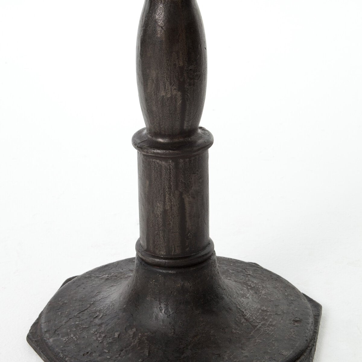 Detailed picture of a hexagonal metal pedestal table base on a white background.