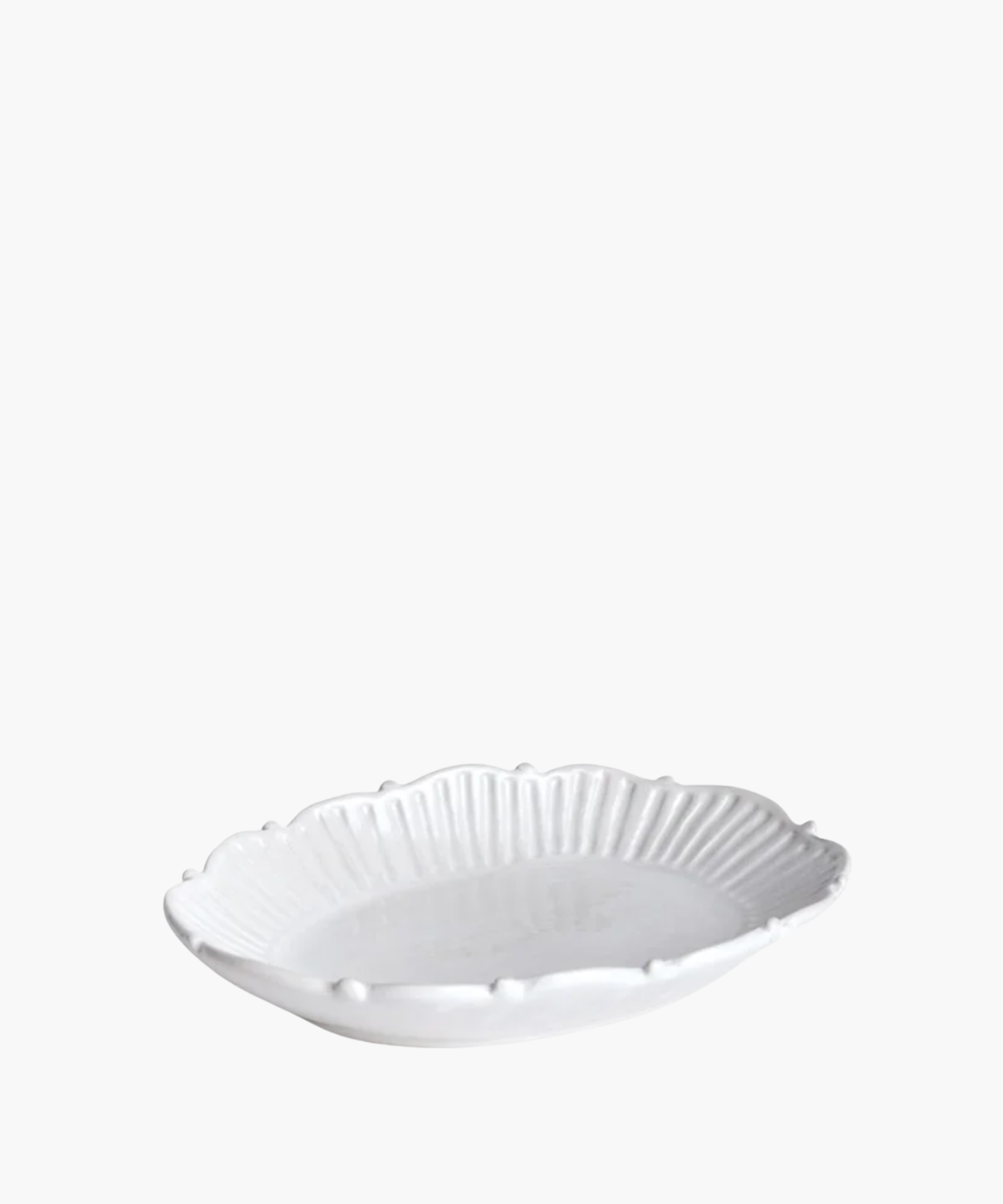 Small white ceramic catchall tray with a decorative rim.
