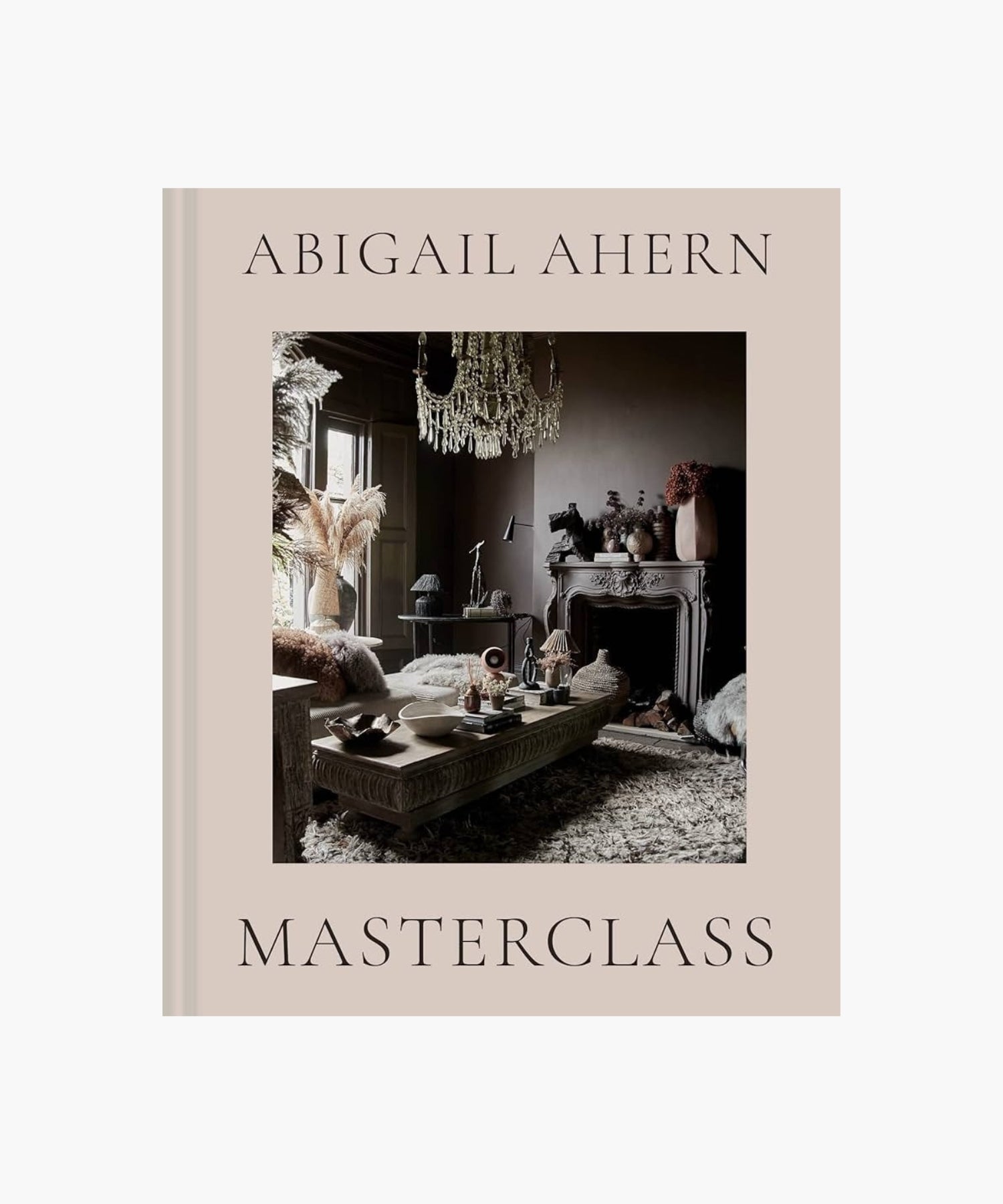 The cover of the book "Masterclass" by Abigail Ahern features an elegant room with moody decor, featuring a chandelier, ornate fireplace, and textured furnishings. | Wildwood Home Co.
