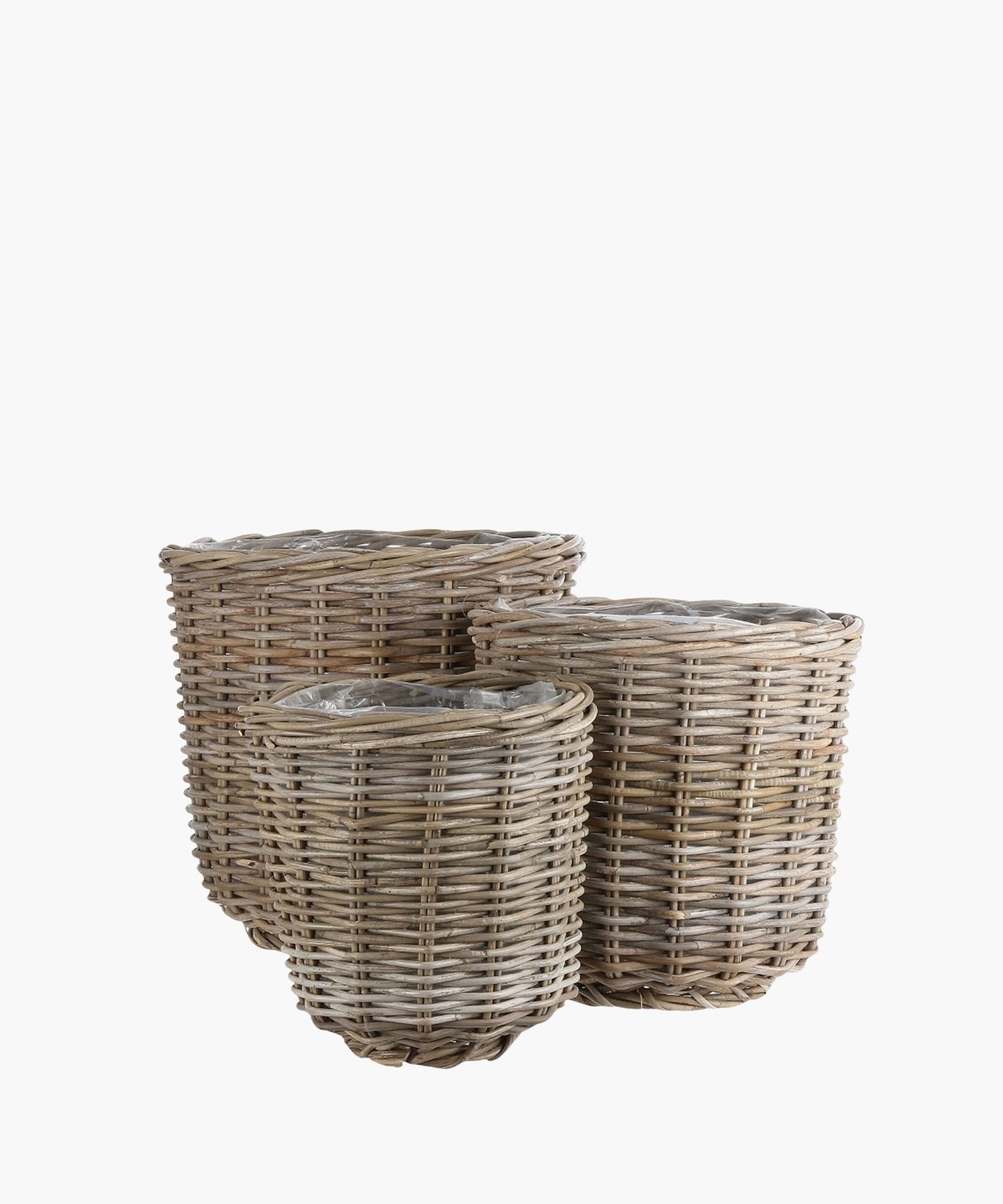 Three round wicker baskets of various sizes are shown against a white background conveying a natural, rustic appearance. | Wildwood Home Co.
