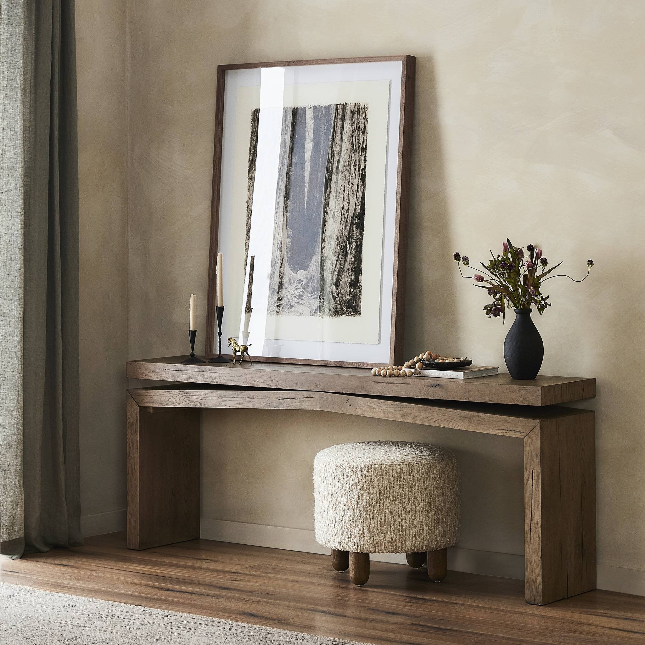 Wooden console table with decorative items against a beige wall. | Wildwood Home Co.