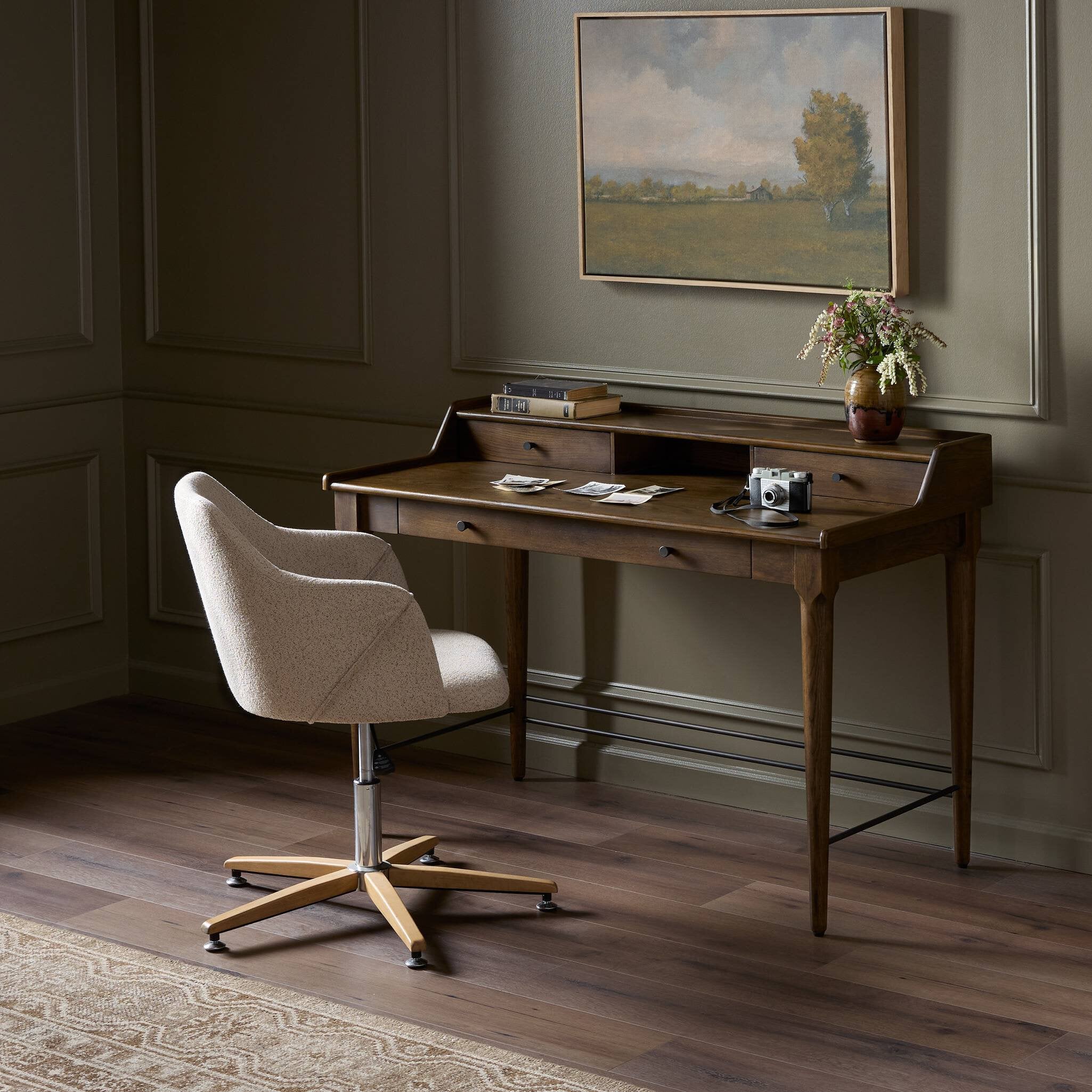 Wooden desk with a chair in a room with a painting on the wall. | Wildwood Home Co.