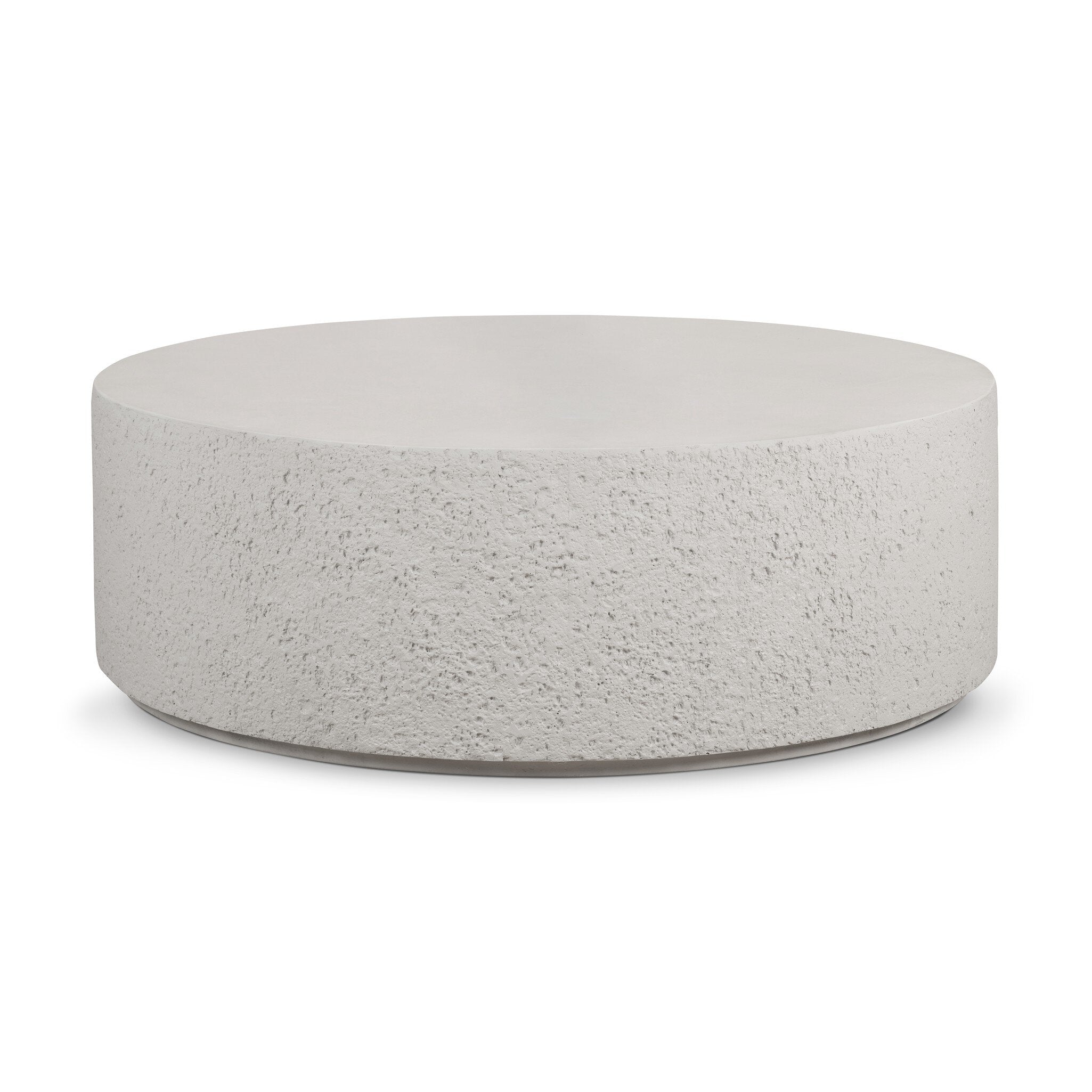 Round concrete coffee table with raw edges and a smooth top on a white background. | Wildwood Home Co.