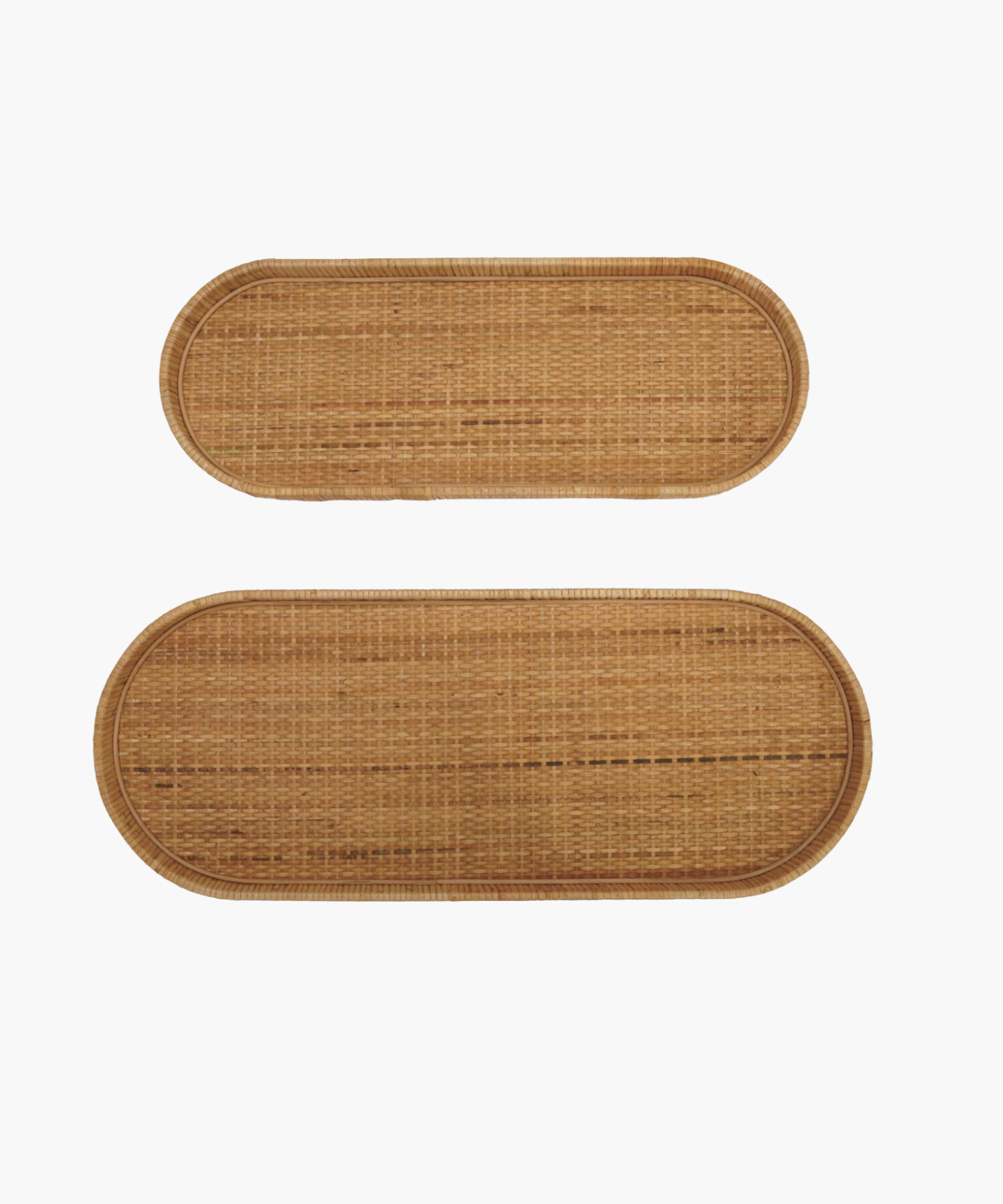 Two oval wicker handwoven trays with rounded edges, one smaller above the larger one, against a white background. Natural, rustic texture.