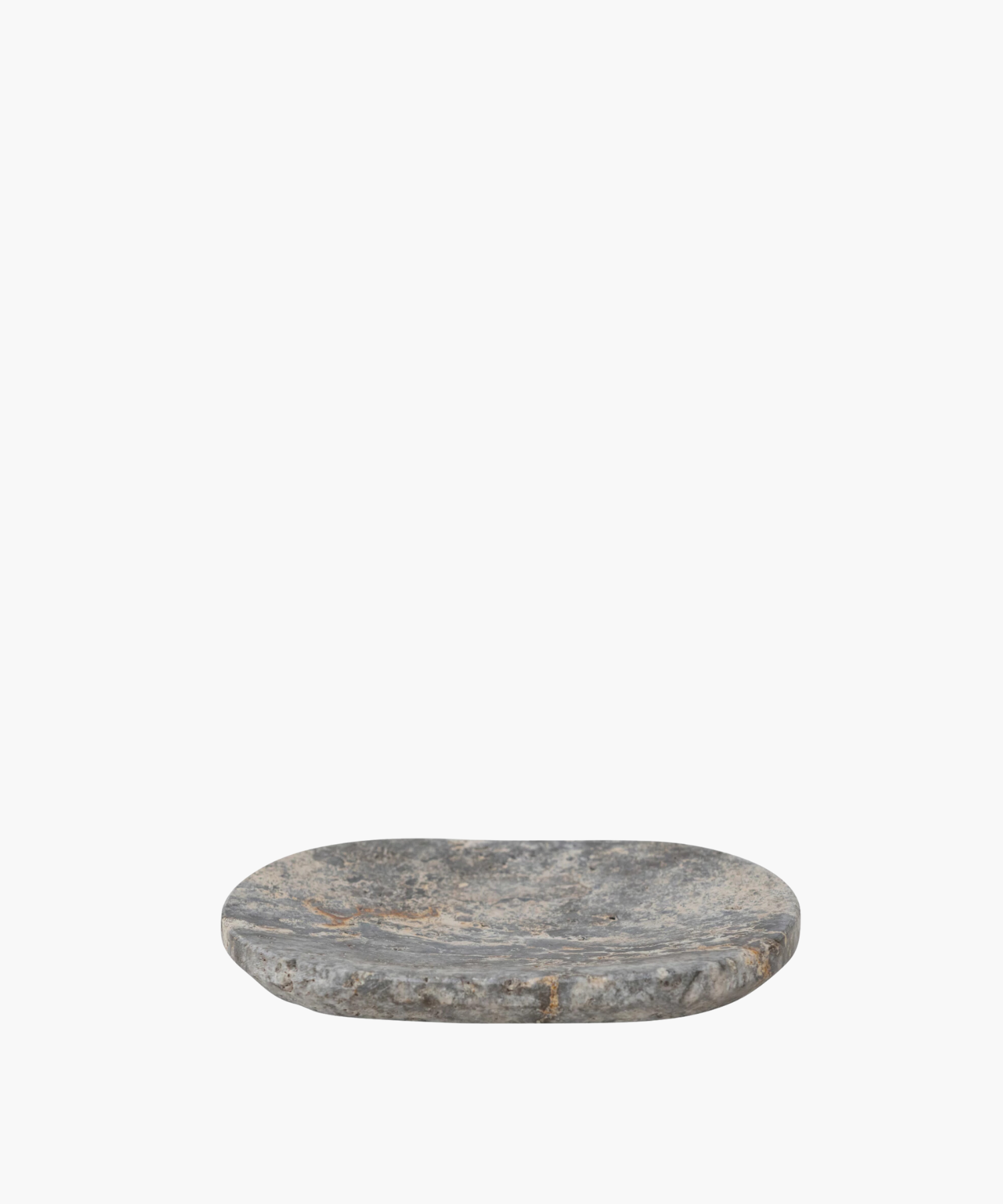 Oval shaped travertine soap dish with a rough, textured surface in shades of gray and hints of brown. It conveys a rustic, natural, and minimalist aesthetic. | Wildwood Home Co.
