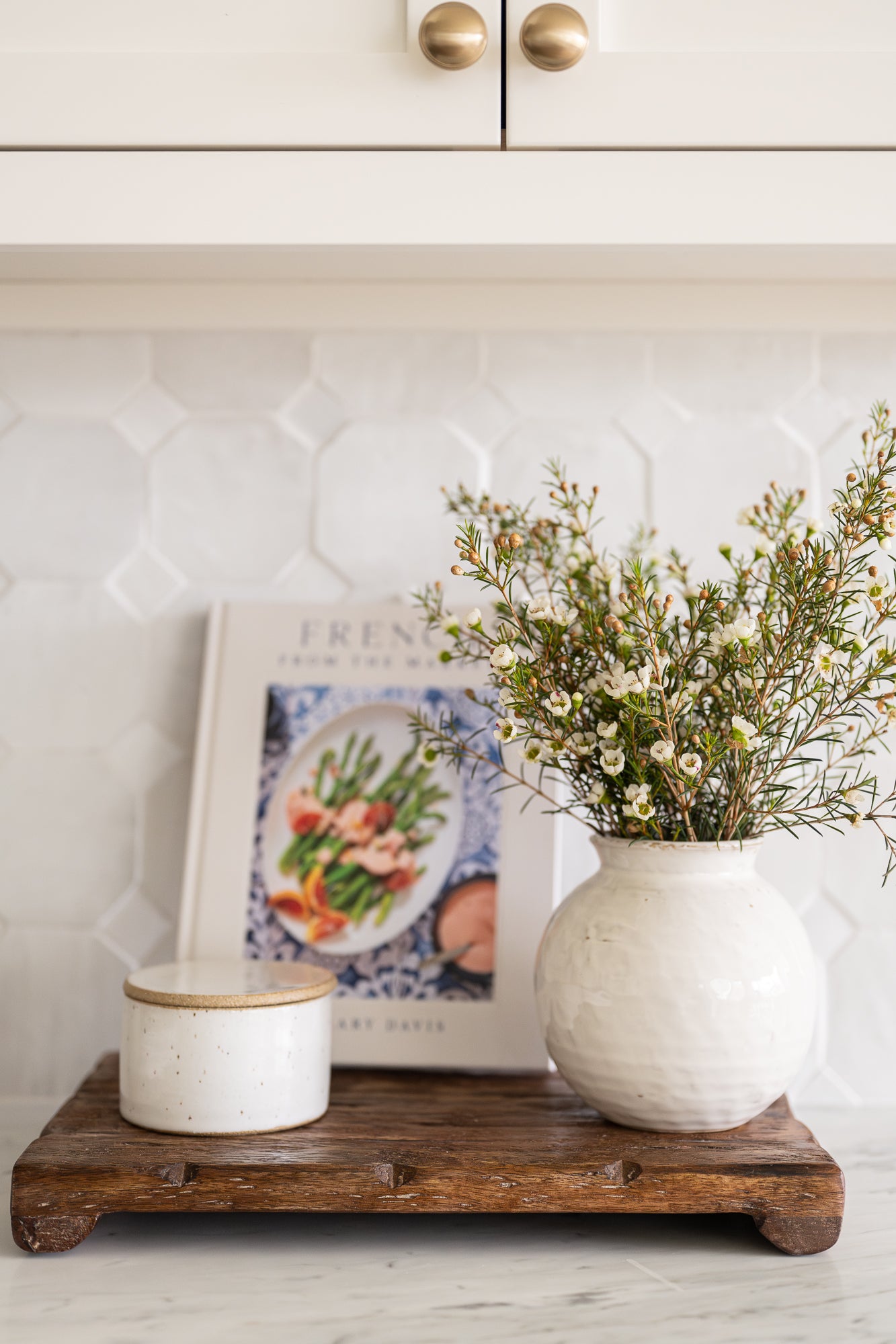 Round ceramic vase with a textured white glaze styled with florals and kitchen essentials. | Wildwood Home Co.