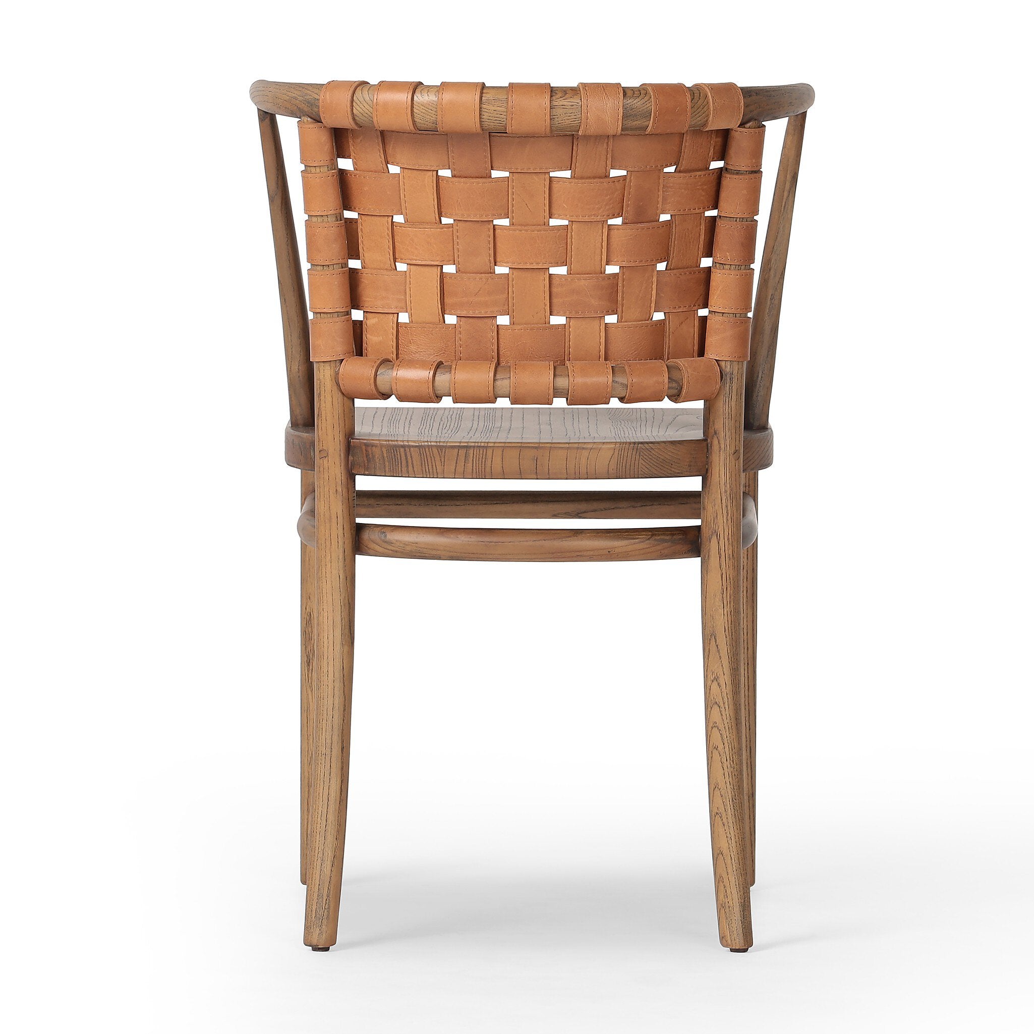 The back of a wooden dining chair with barrel seatback of woven leather on a white background.