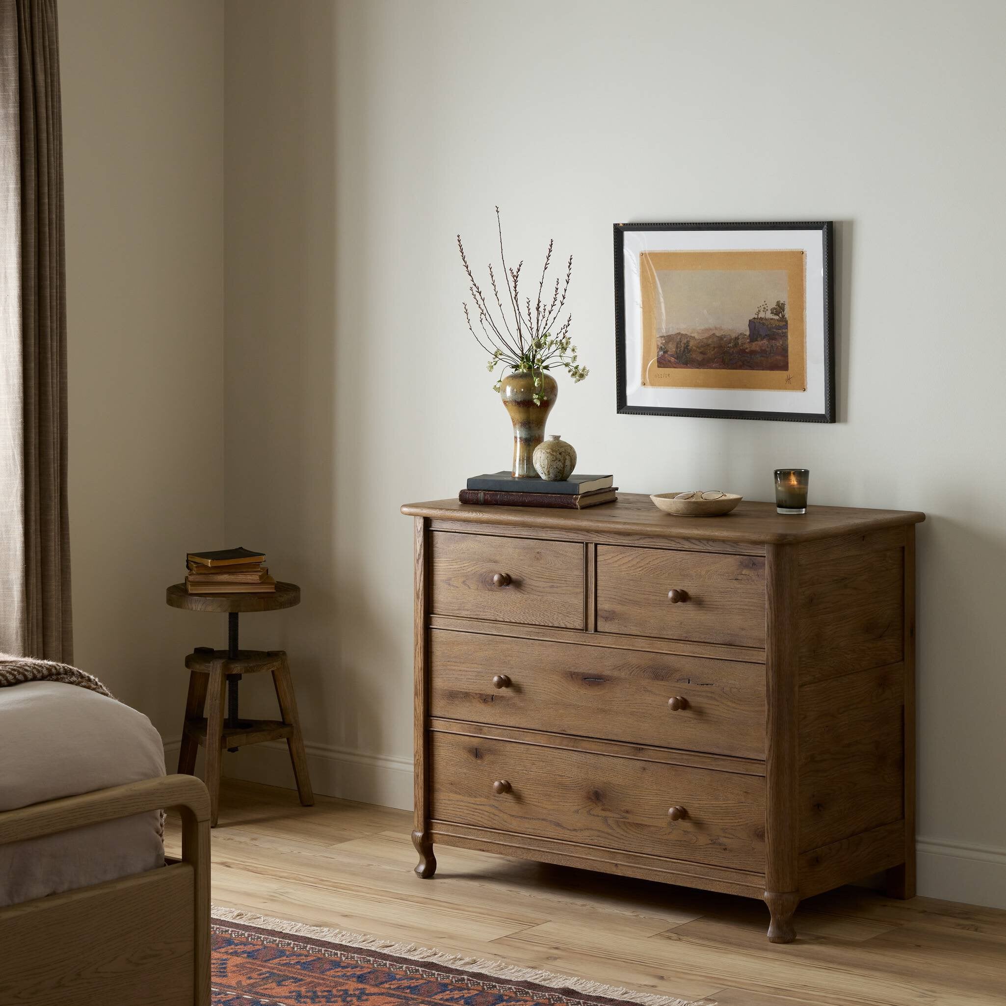 Wooden dresser with decorative items in a bedroom setting. | Wildwood Home Co.