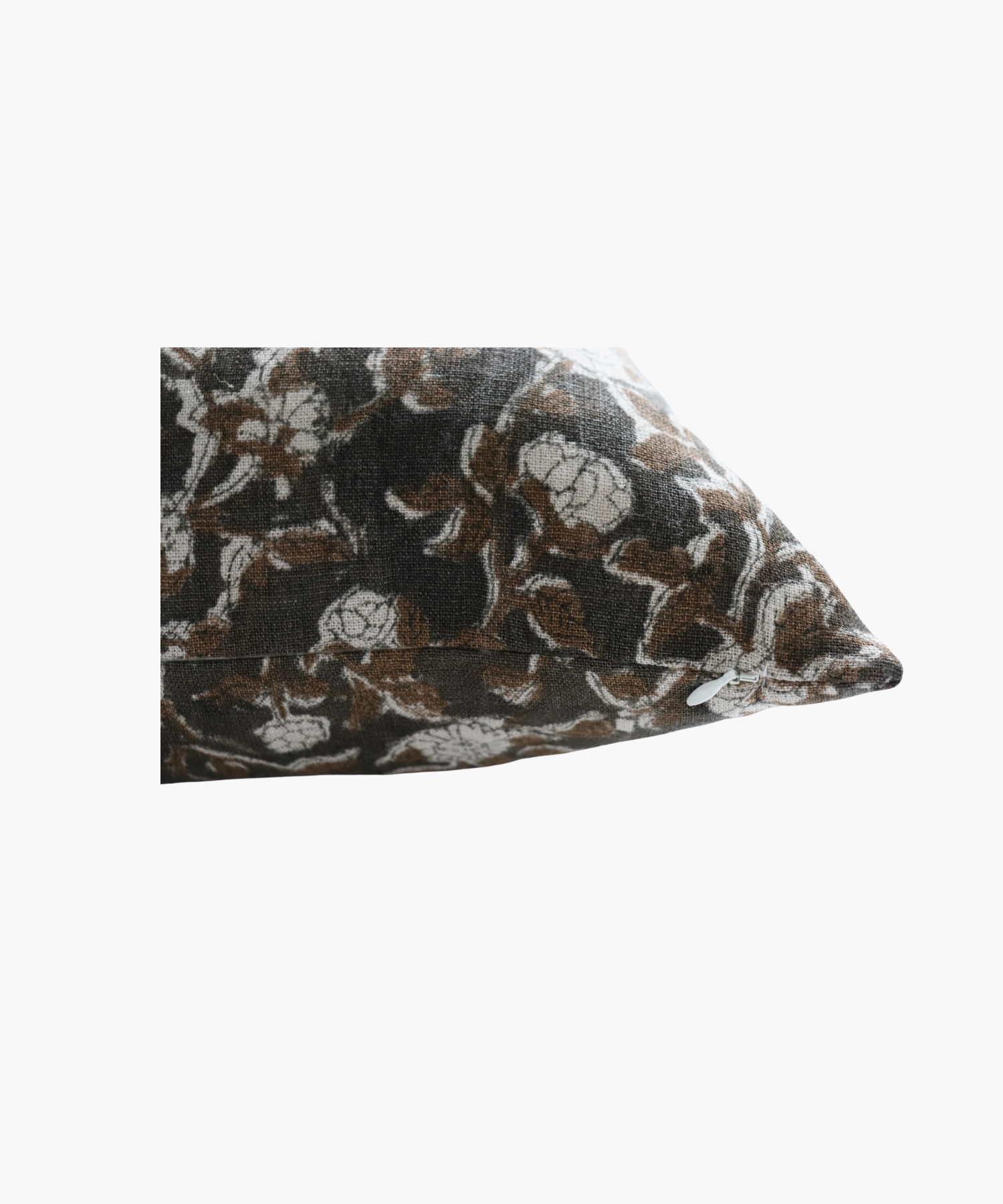 A detailed picture of a rectangular pillow highlighting its floral pattern of brown leaves and white flowers on a dark background. The design is intricate and evokes a cozy feel. | Wildwood Home Co.