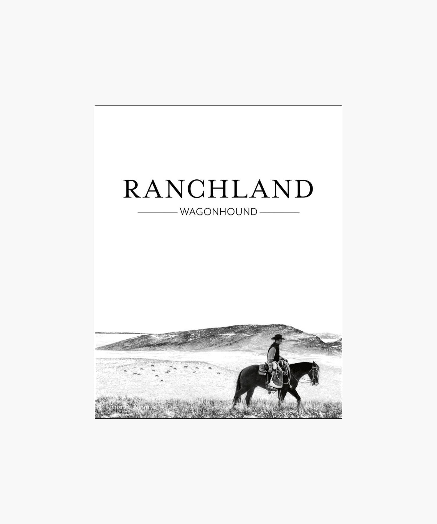 The cover of the book "Ranchland: Wagonhounse" featuring a black-and-white image of a cowboy riding a horse across an expansive, open ranch landscape. | Wildwood Home Co.