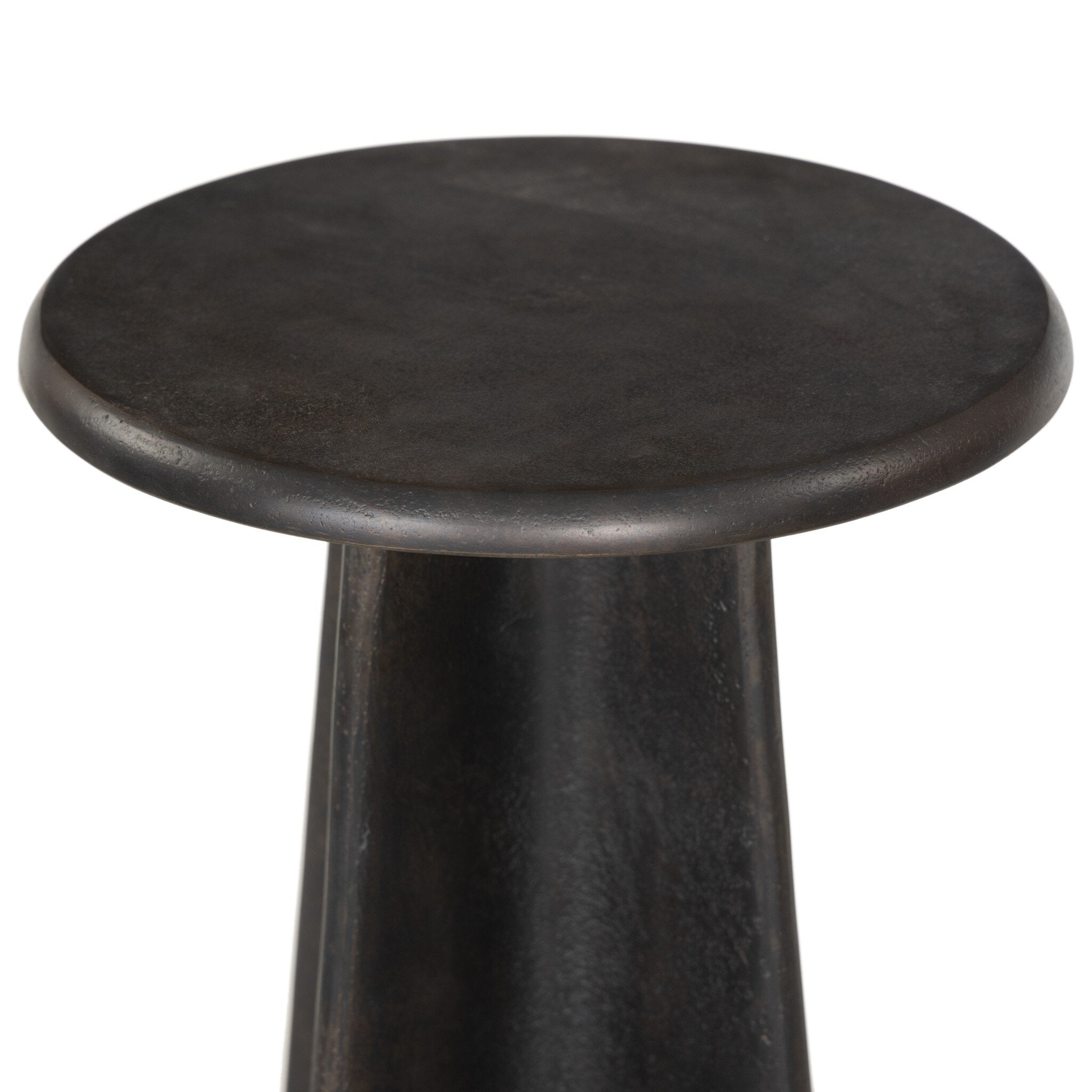 Distressed bronze side table with a round top and X-shaped base on a white background.