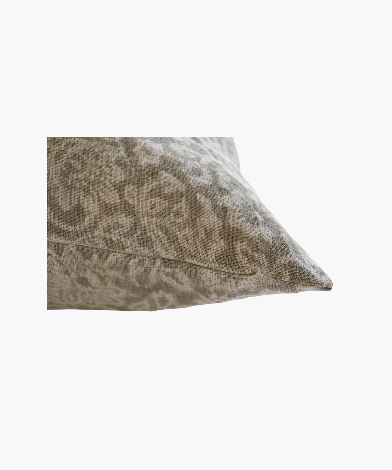 A detailed picture of a beige pillow highlighting its light gray, intricate floral pattern. The design is elegant, adding a soft, decorative touch suitable for a cozy setting.