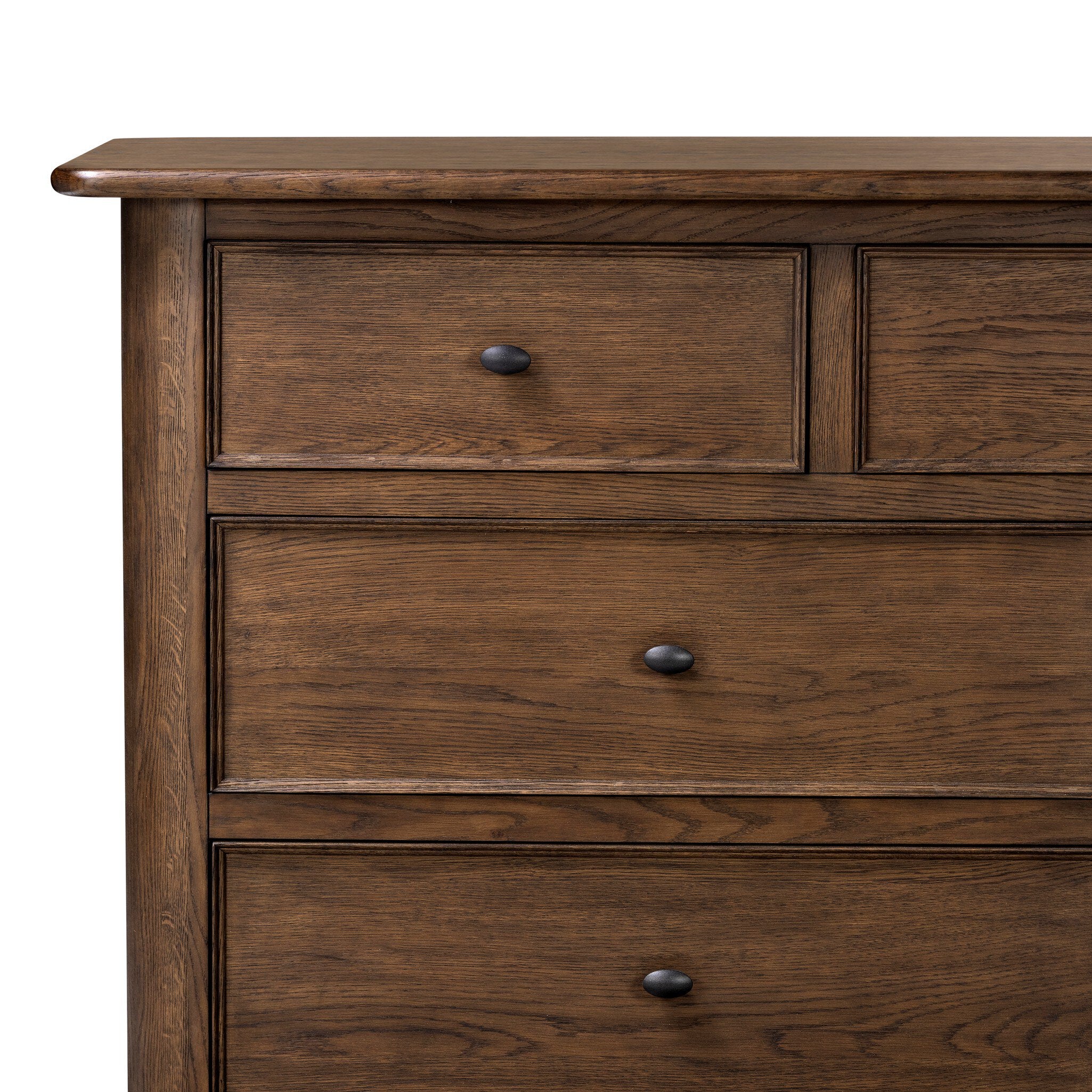 Close up of a wooden dresser with multiple drawers on a white background.
