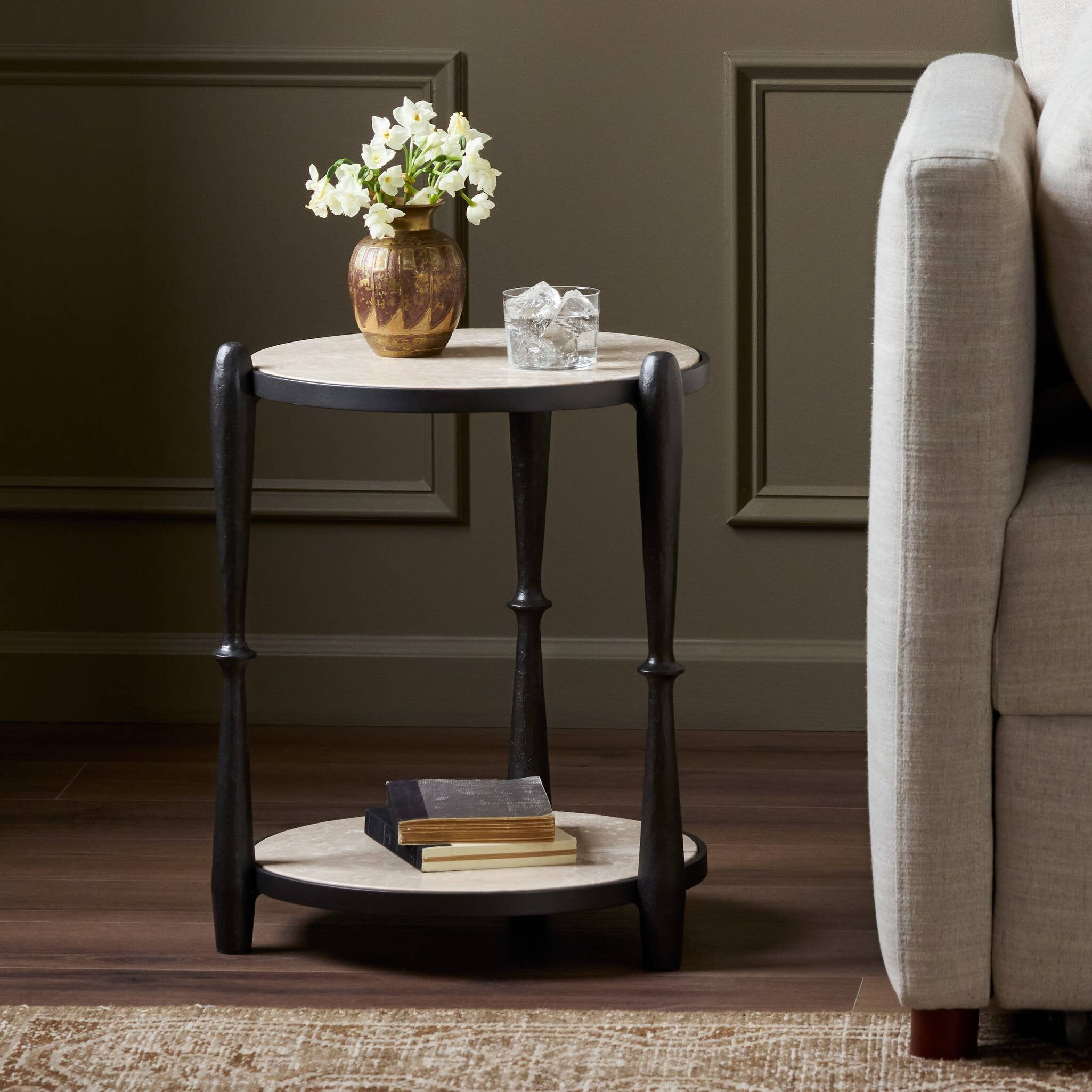 Small round side table with decorative items in a living room setting. | Wildwood Home Co.