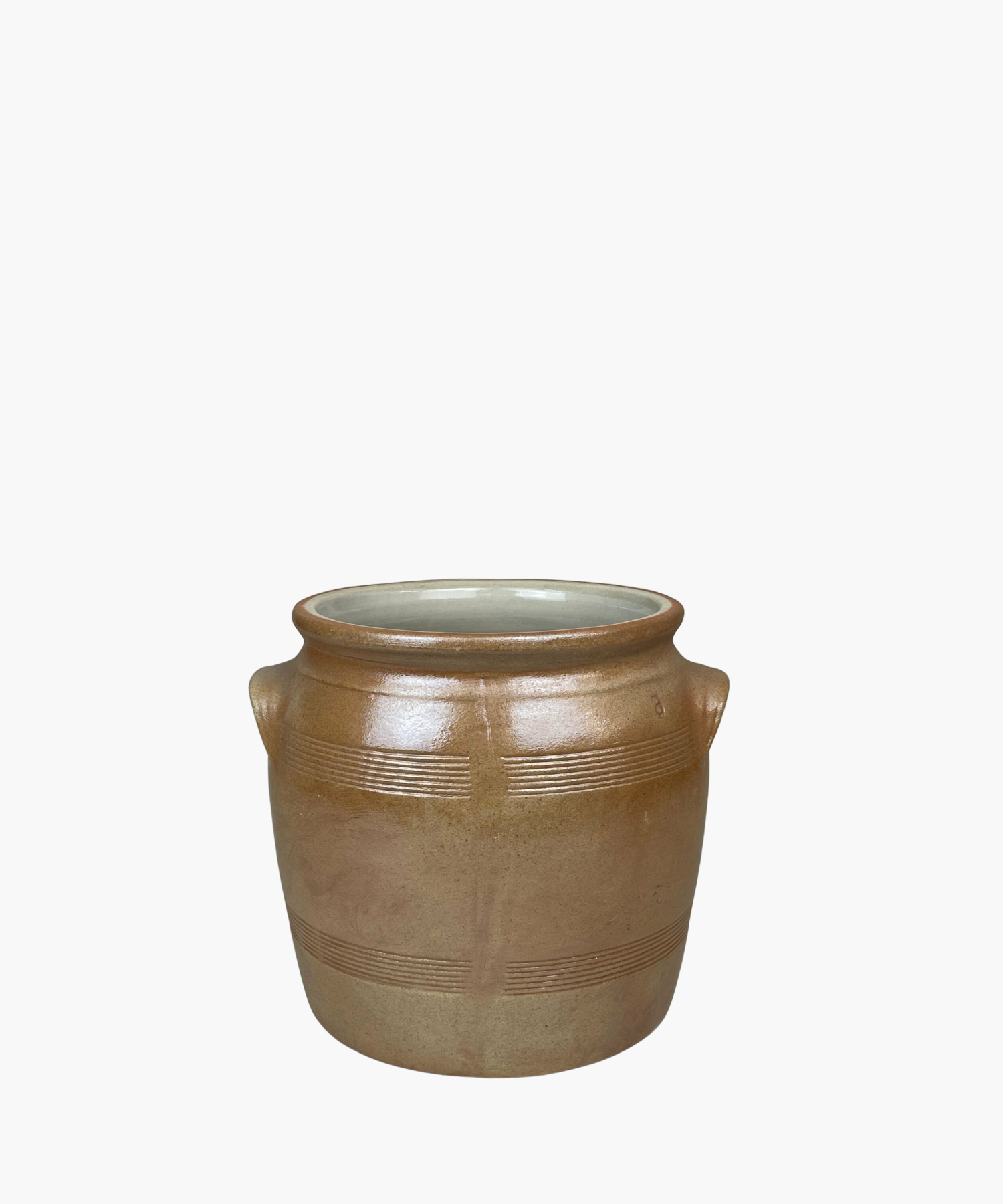 A rustic, brown salt crock with two small handles and horizontal etched lines. The pot has a smooth finish, conveying a simple, earthy elegance.