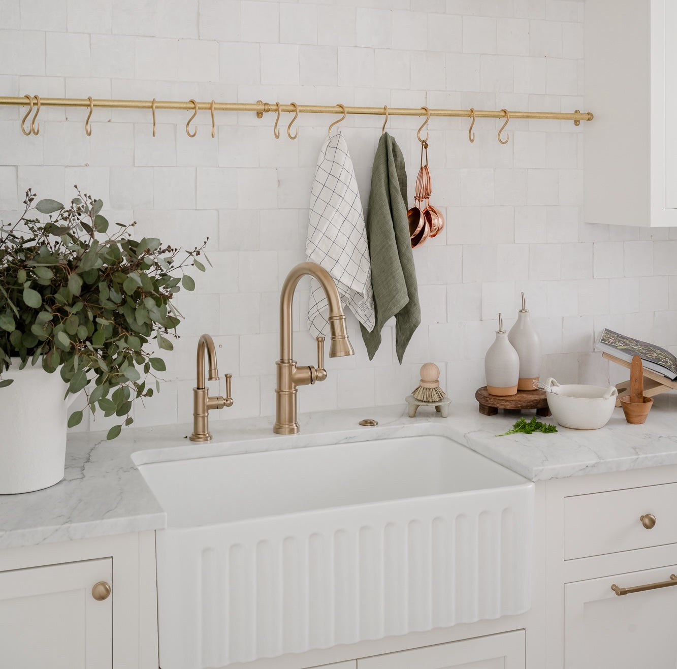 Wooden dish scrubber or saucepan brush with natural bristles, circular handle on top styled in a kitchen with neutral tones. Simple, eco-friendly cleaning tool with a minimalistic vibe. | Wildwood Home Co.