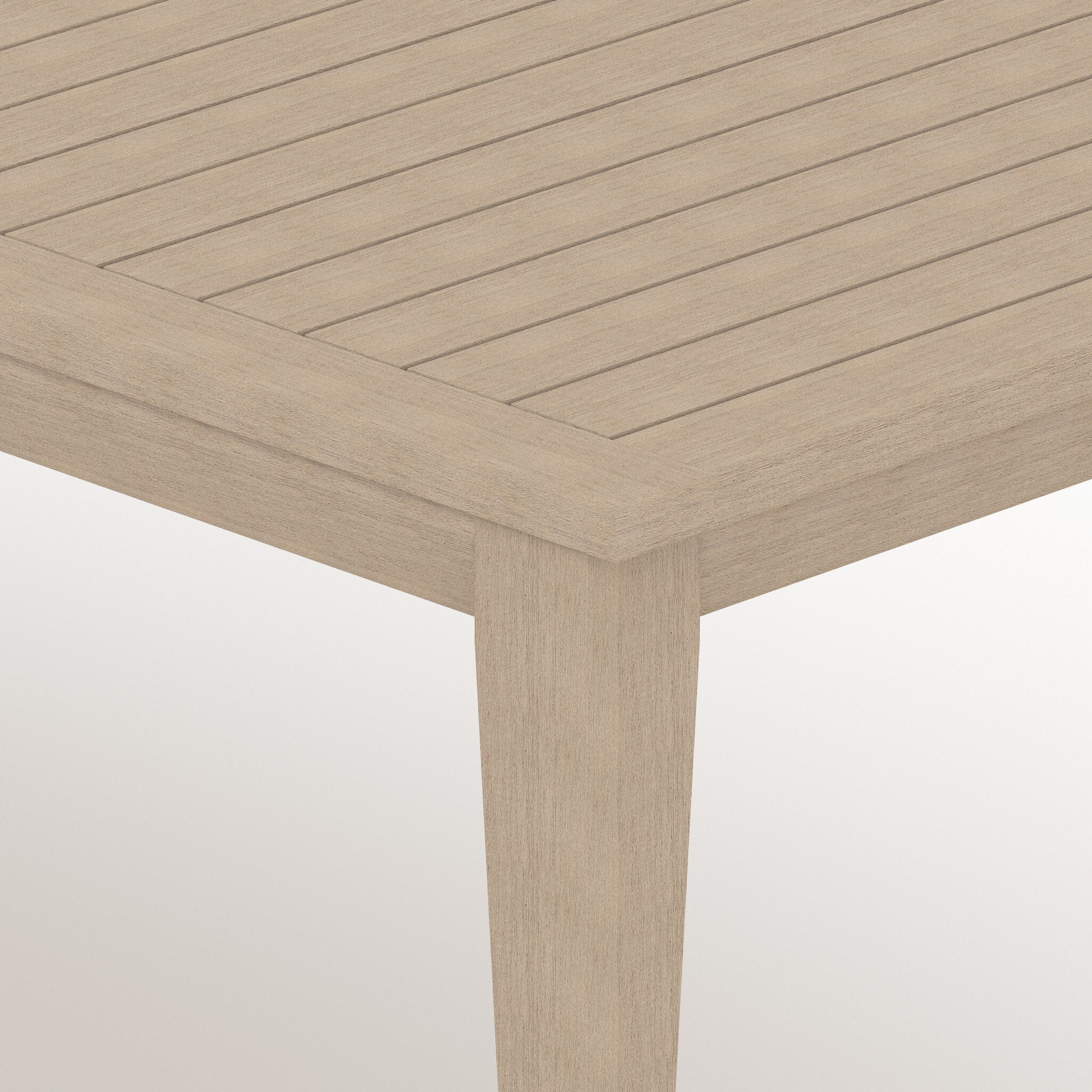 Close-up of a wooden table with a light brown finish on a white background.