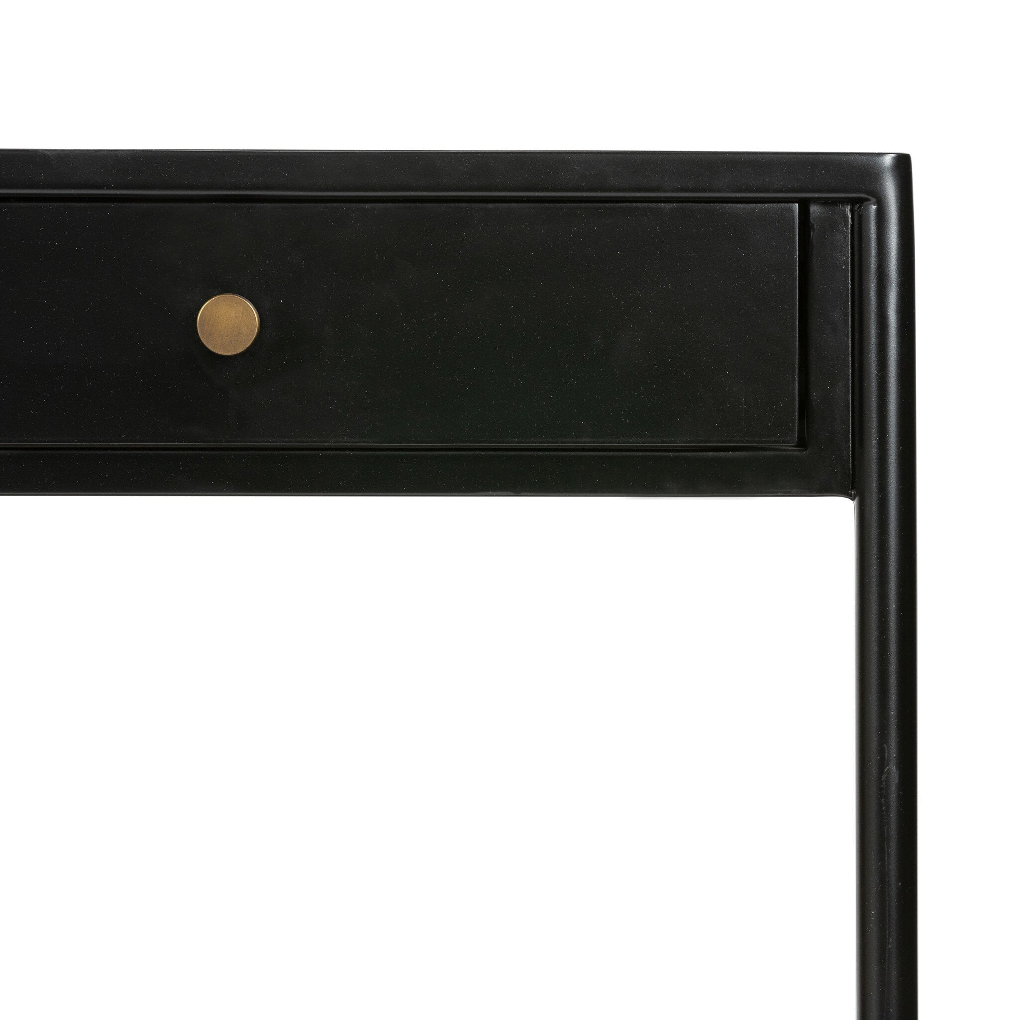 Close up of a black desk with a drawer and gold handle on a white background.