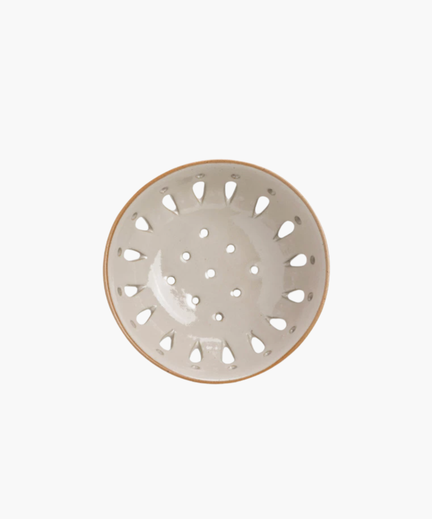 A beige ceramic colander with a light brown rim, featuring round holes and teardrop-shaped cutouts, standing out against a plain white background. | Wildwood Home Co.