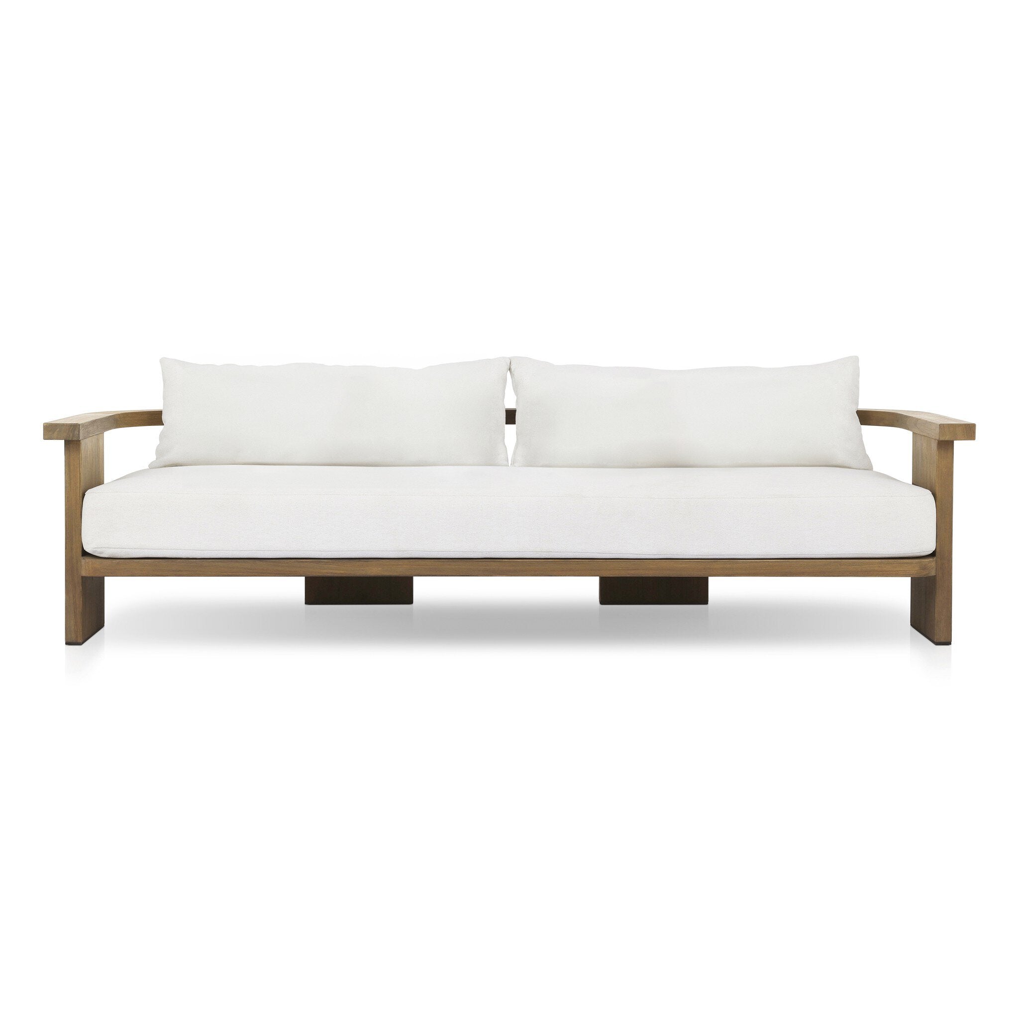 Outdoor sofa with curved wooden frame out of teak and white linen cushions on a white background. | Wildwood Home Co.