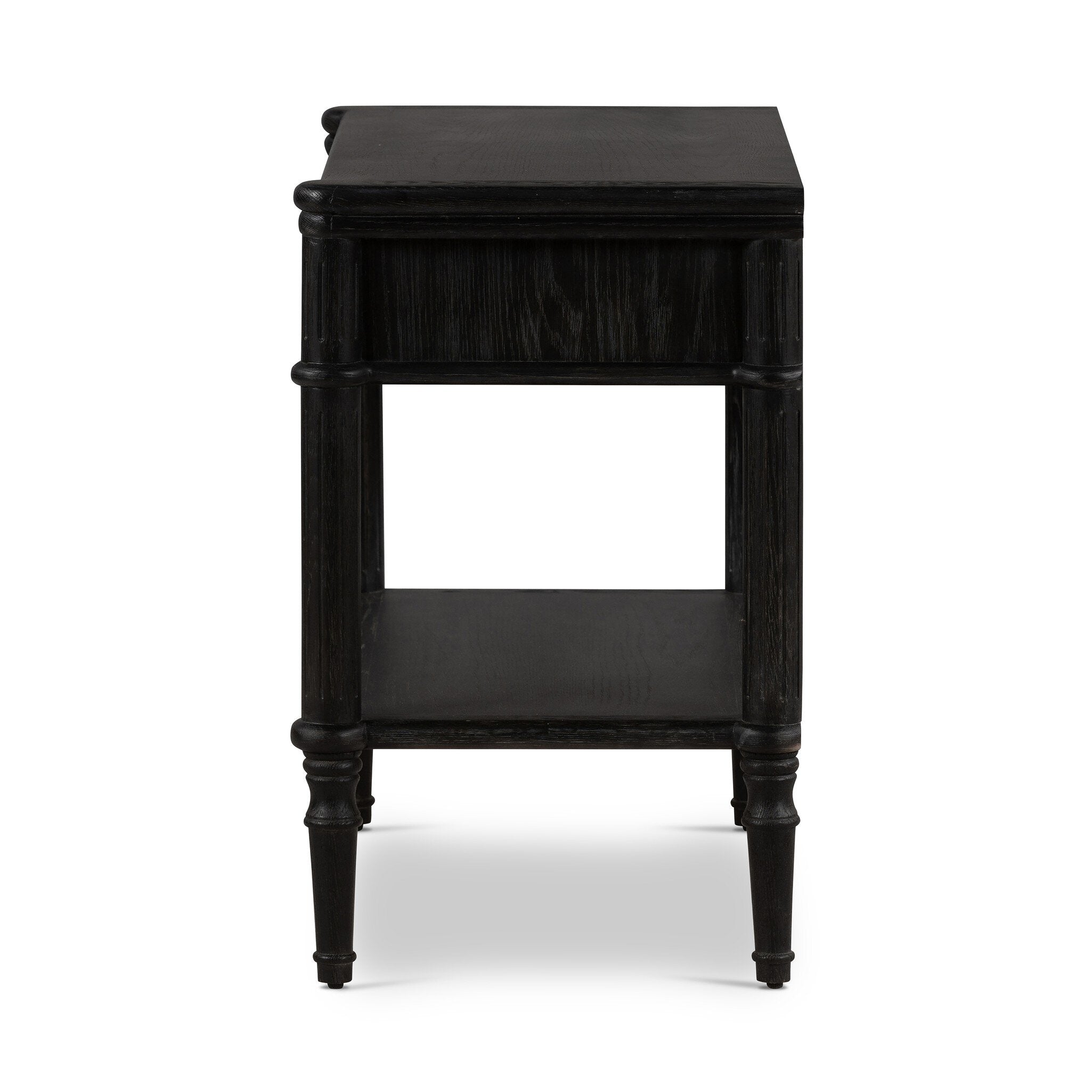 Side profile distressed black oak nightstand with a drawer and a shelf on a white background.