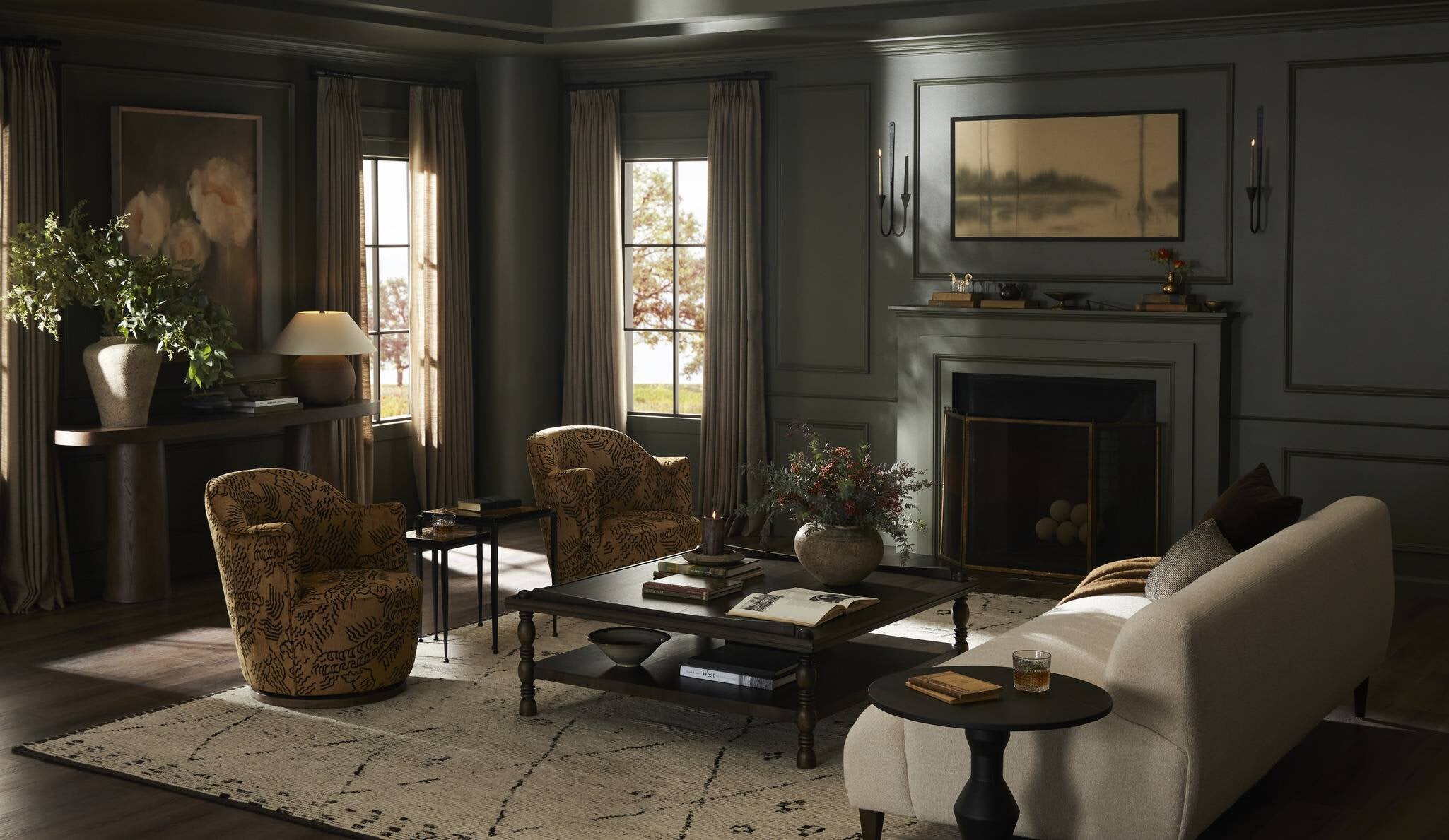 Cozy living room with a fireplace, chairs, and a coffee table. | Wildwood Home Co.